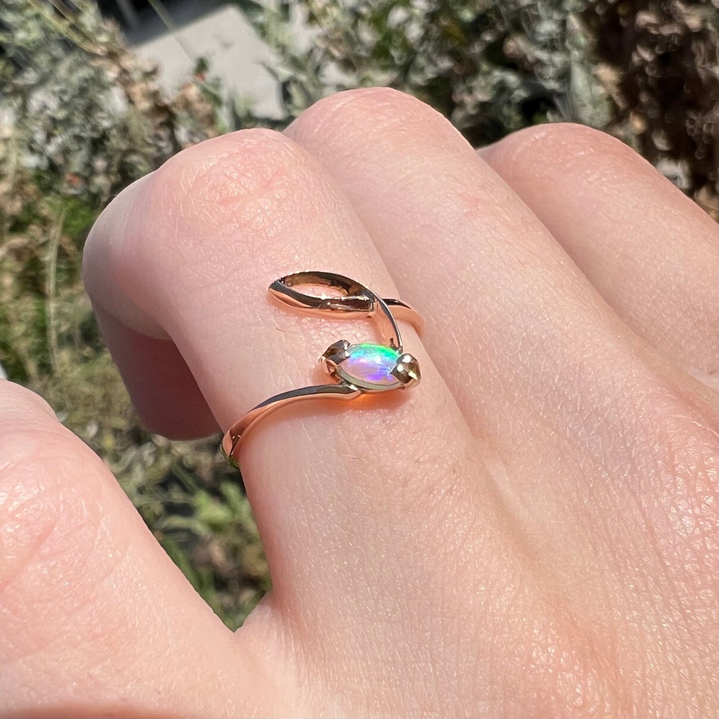 An 18 karat yellow gold Boho style ring set with a natural Australian opal.