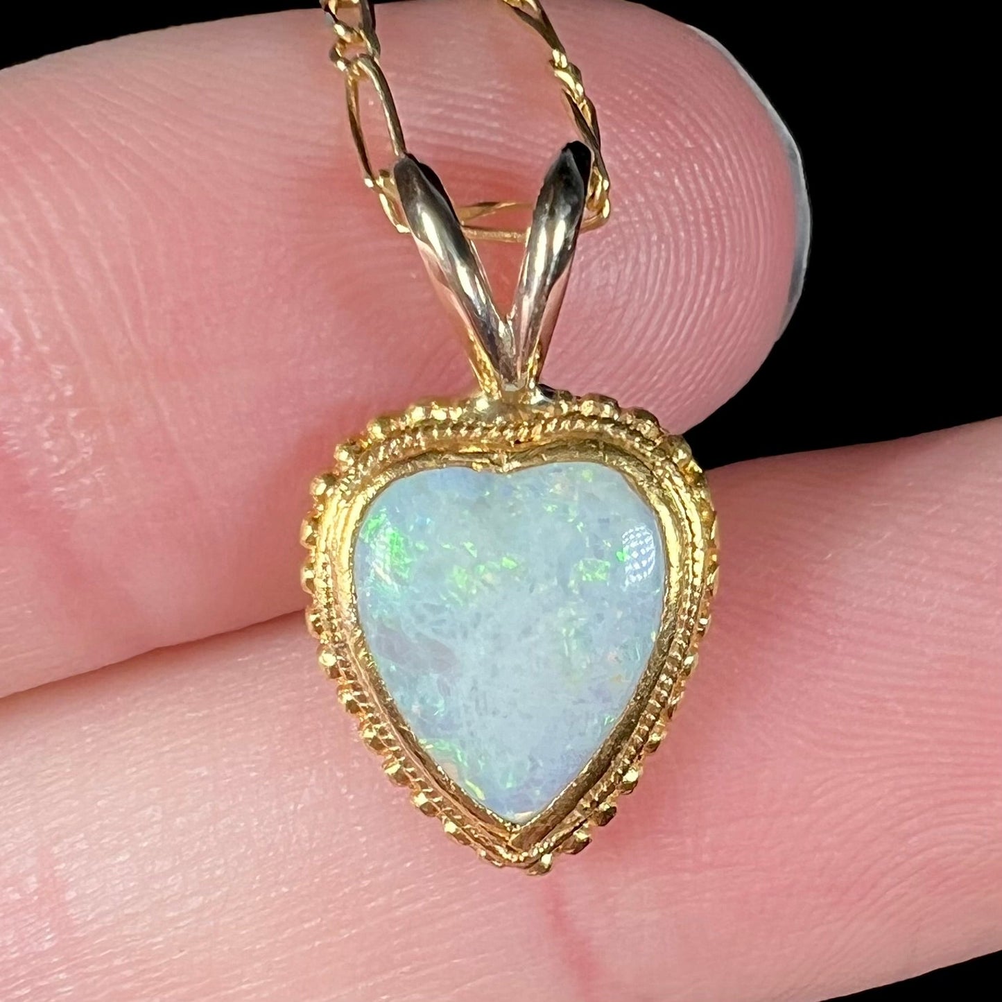 An 18 karat yellow gold heart necklace mounted with a heart shaped opal.
