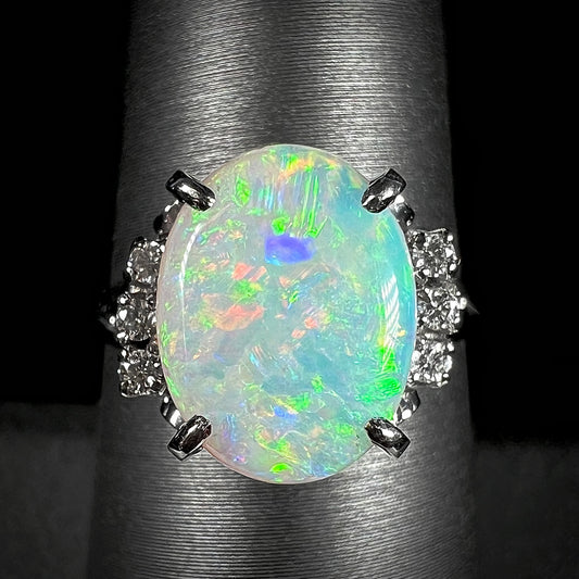A 2.35ct opal and diamond ring in platinum.  The opal shines green and red colors.