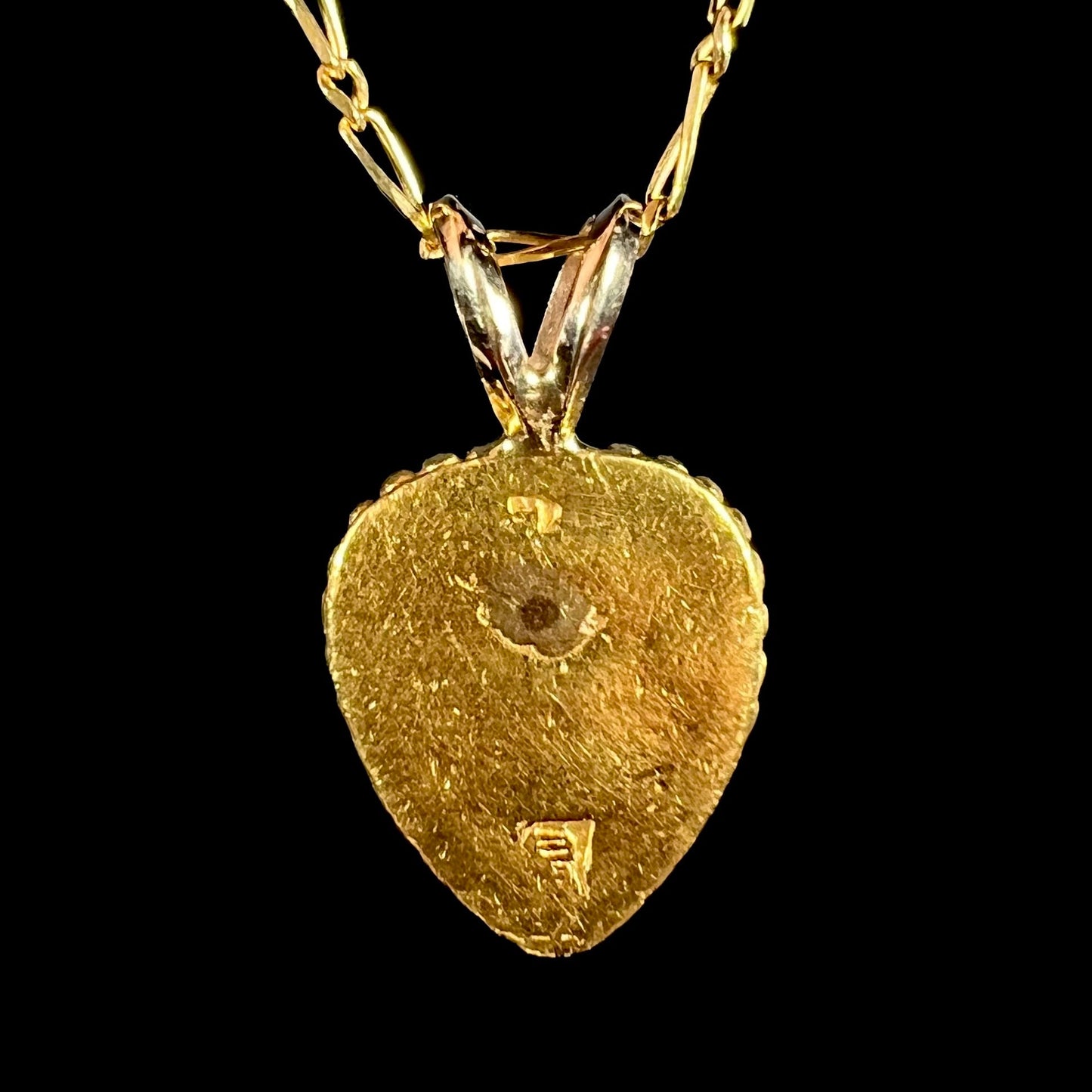 A 22 karat gold heart pendant.