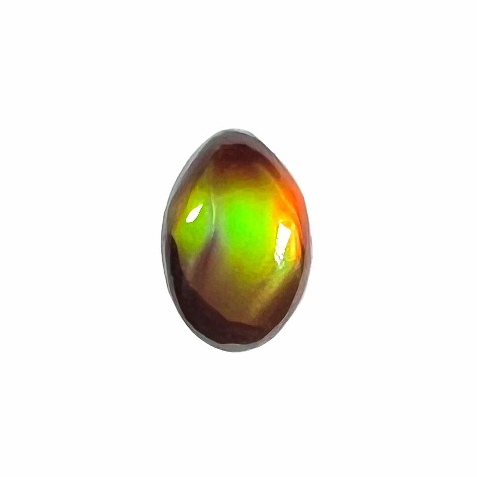 A loose, 3.38ct, pear shaped Mexican fire agate stone.  The stone shines a vivid, bright green color with a purple streak.
