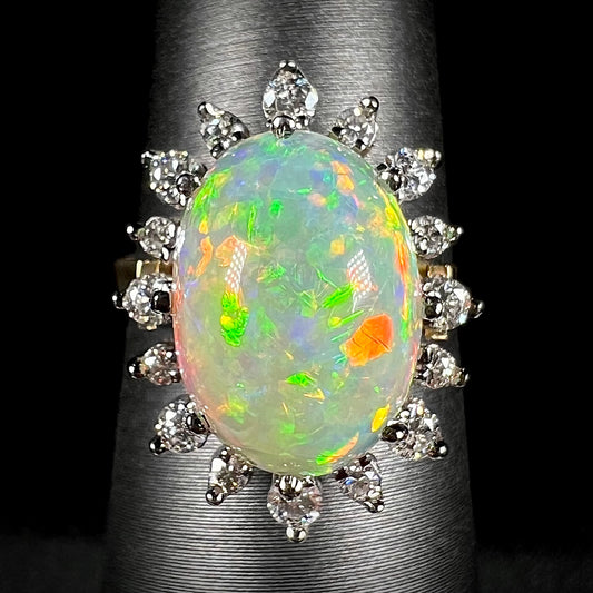A 4.30ct Lightning Ridge crystal fire opal engagement ring set with a diamond halo.  The opal displays rolling red flashes with static green.