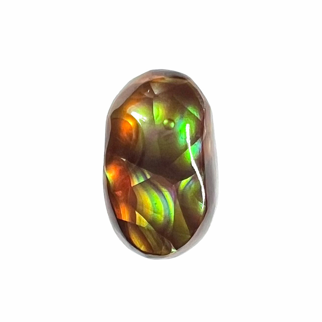 A loose, oval cabochon cut Mexican fire agate stone. The stone has multi-colored banding with blue overtones.