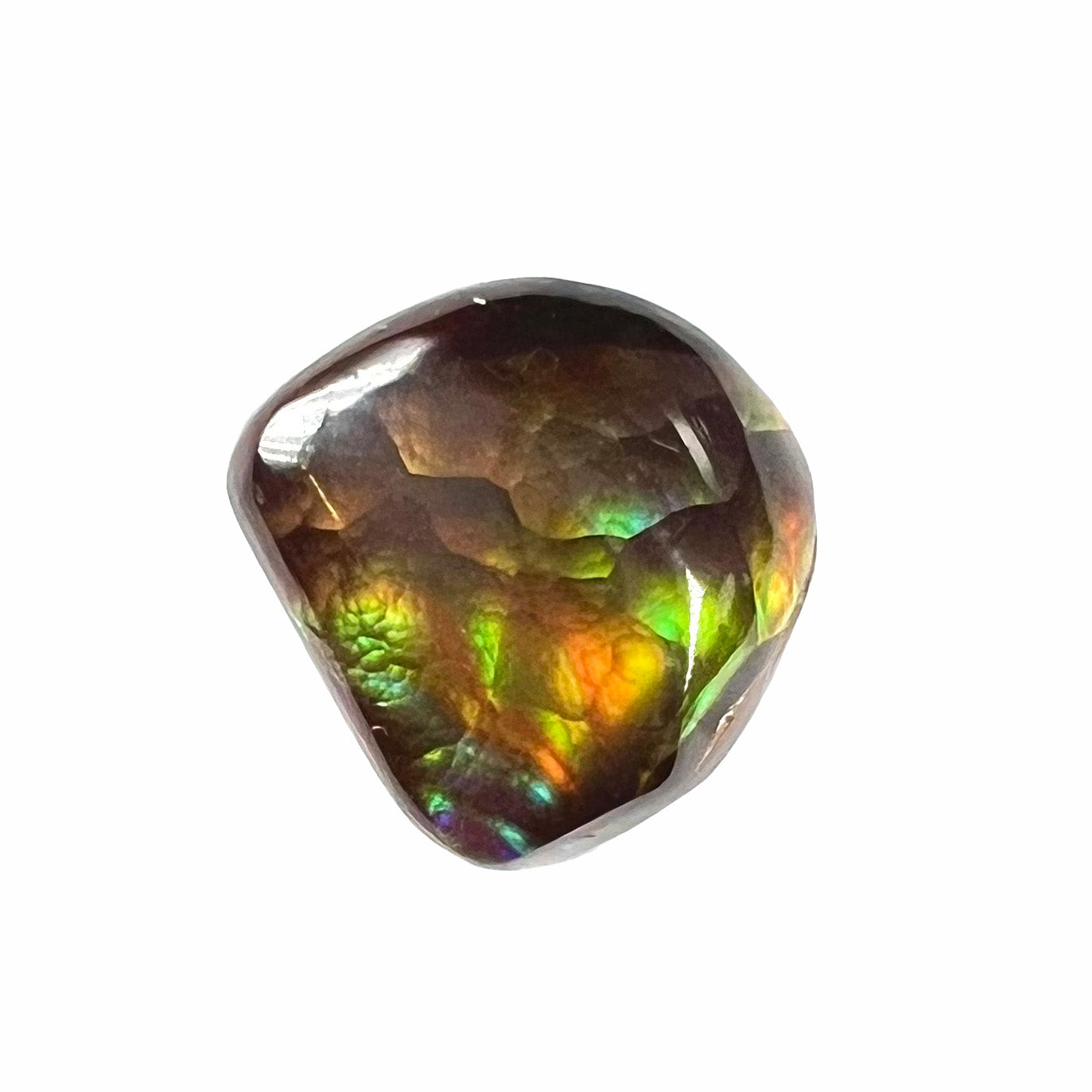 A freeform cabochon cut Mexican fire agate stone.  The stone has a bright purple flash with green, yellow, and orange.