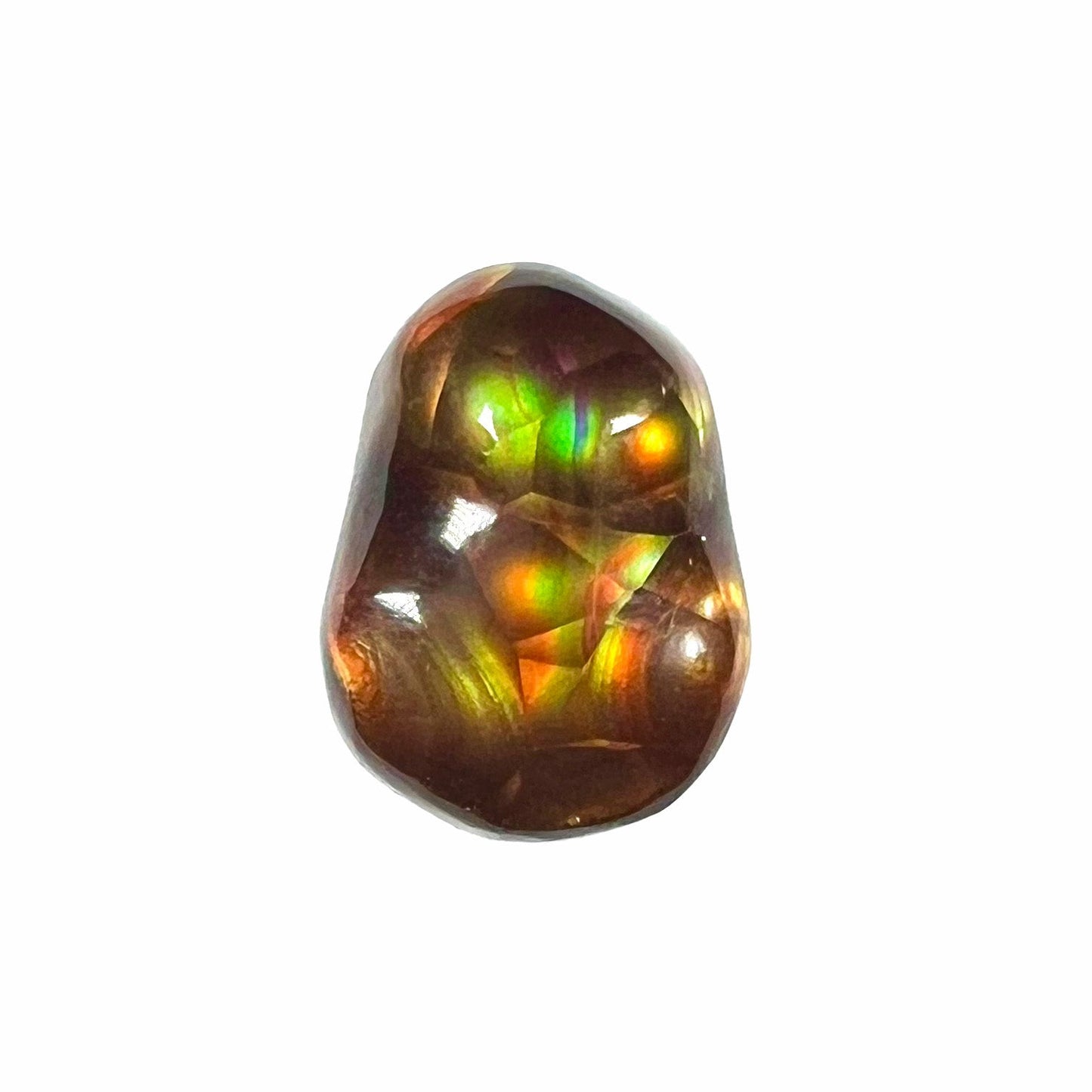 A loose, freefrom cabochon cut Mexican fire agate stone. The stone has red, green, yellow, and purple banding.