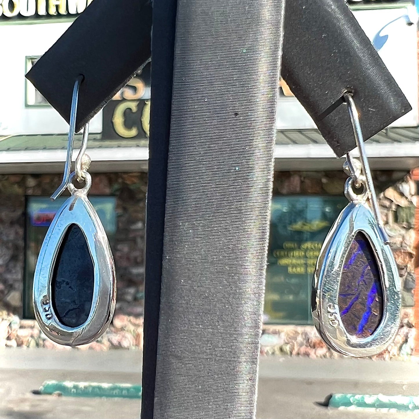 A pair of handmade sterling silver boulder opal French wire dangle earrings.  We named them Ryan and Harris.