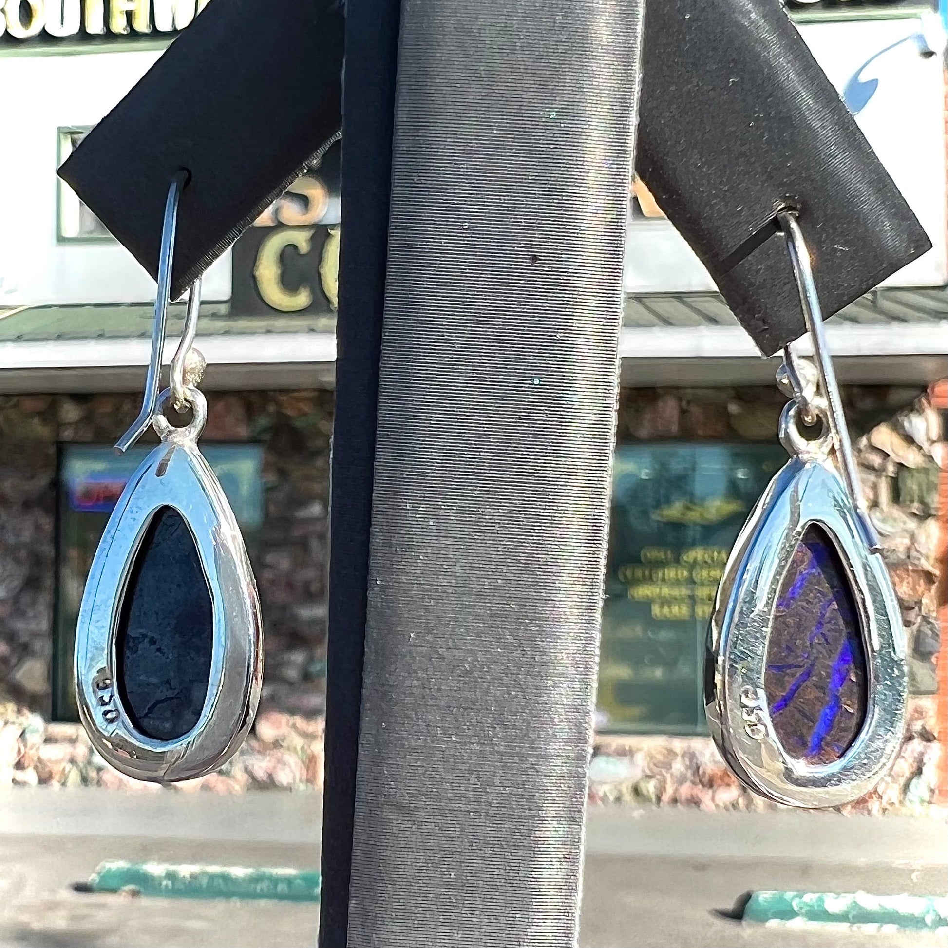 A pair of handmade sterling silver boulder opal French wire dangle earrings.  We named them Ryan and Harris.