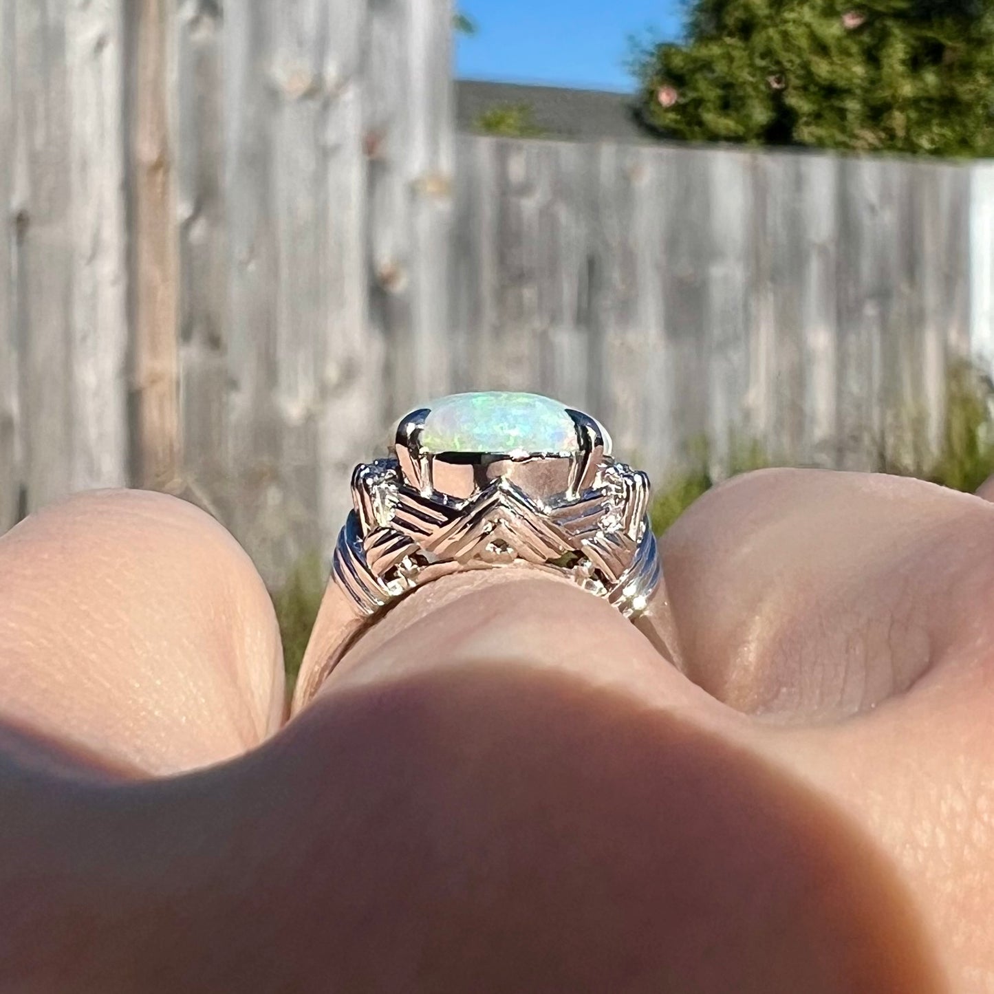 An Art Deco-inspired Coober Pedy opal and diamond statement ring in platinum.