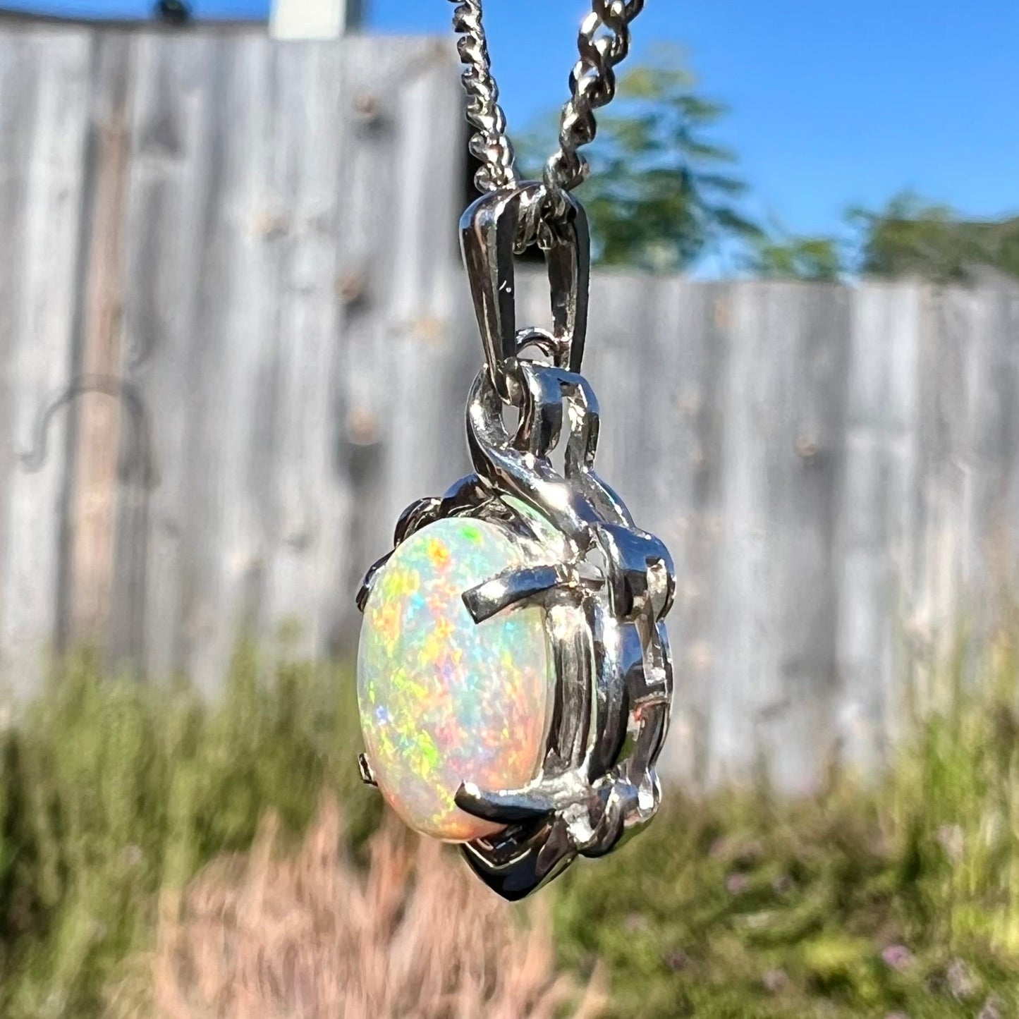 A platinum opal necklace on a platinum chain. The opal weighs 1.49ct and has predominantly green color play.
