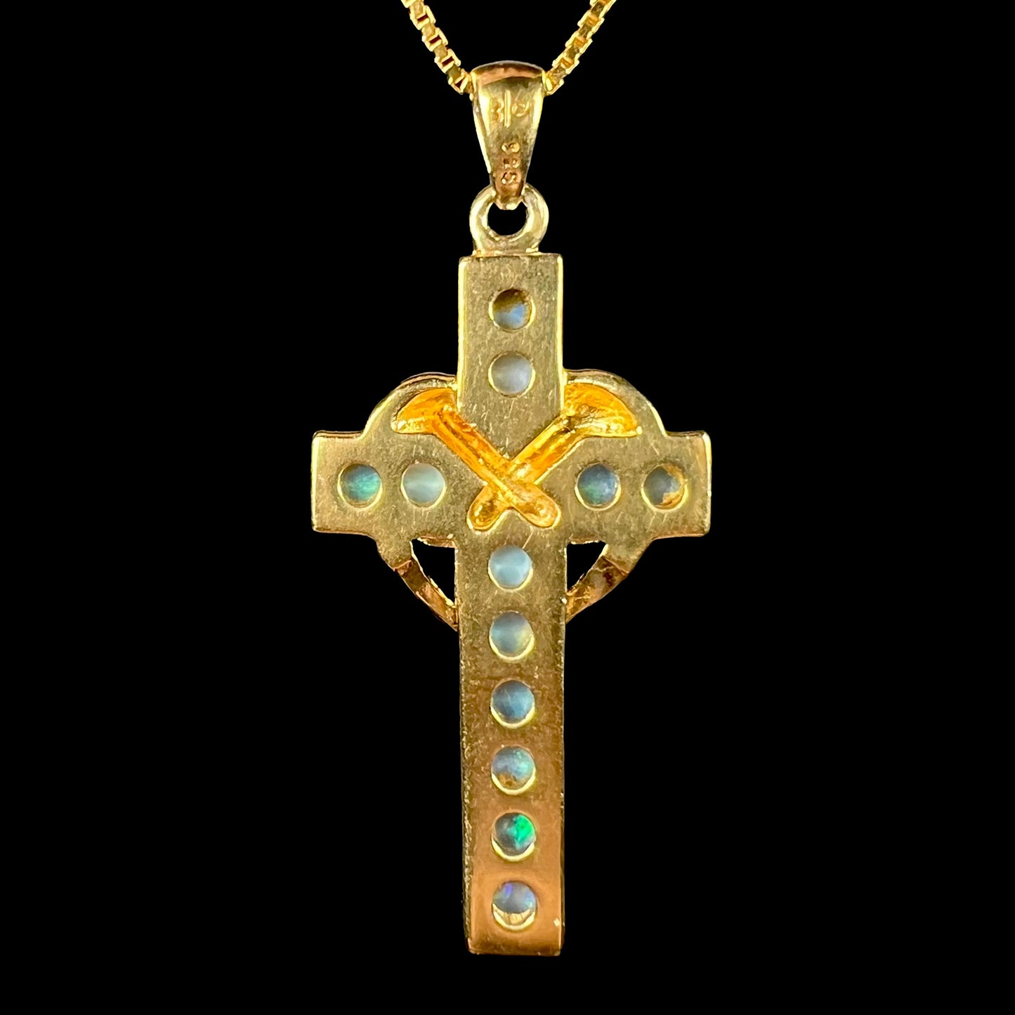 Back of opal cross pendant showing gold plated silver frame and 925 stamp.