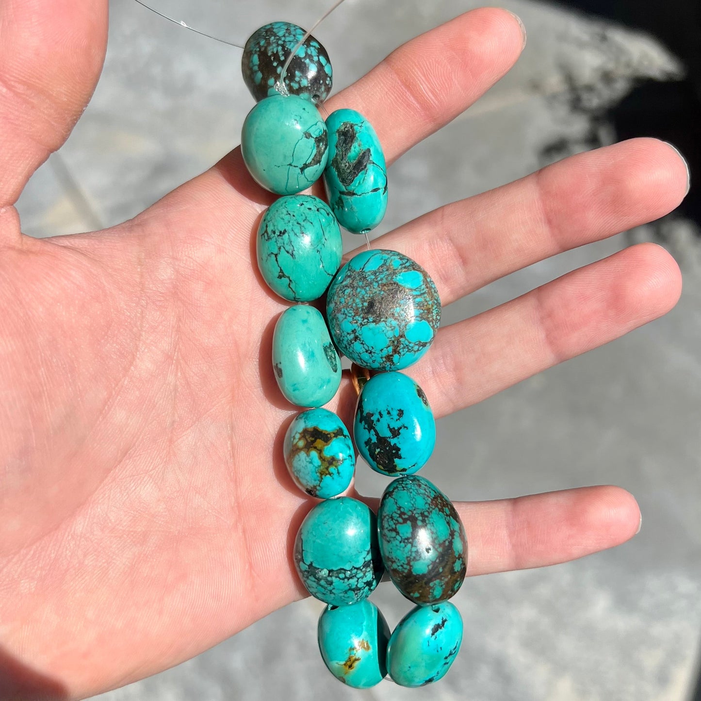 A strand of 12 large, dyed turquoise stones.