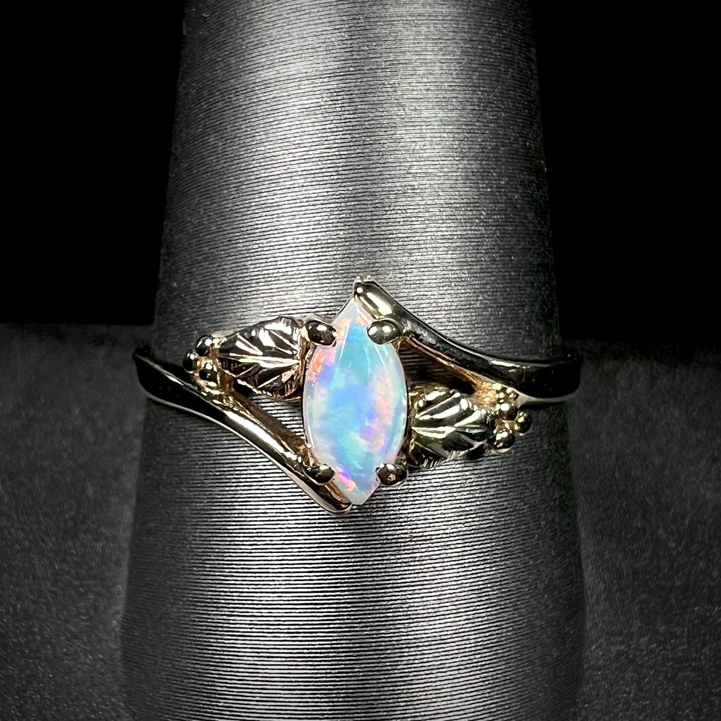 A vintage Blach Hills gold ring mounted with a marquise cut lab created opal.