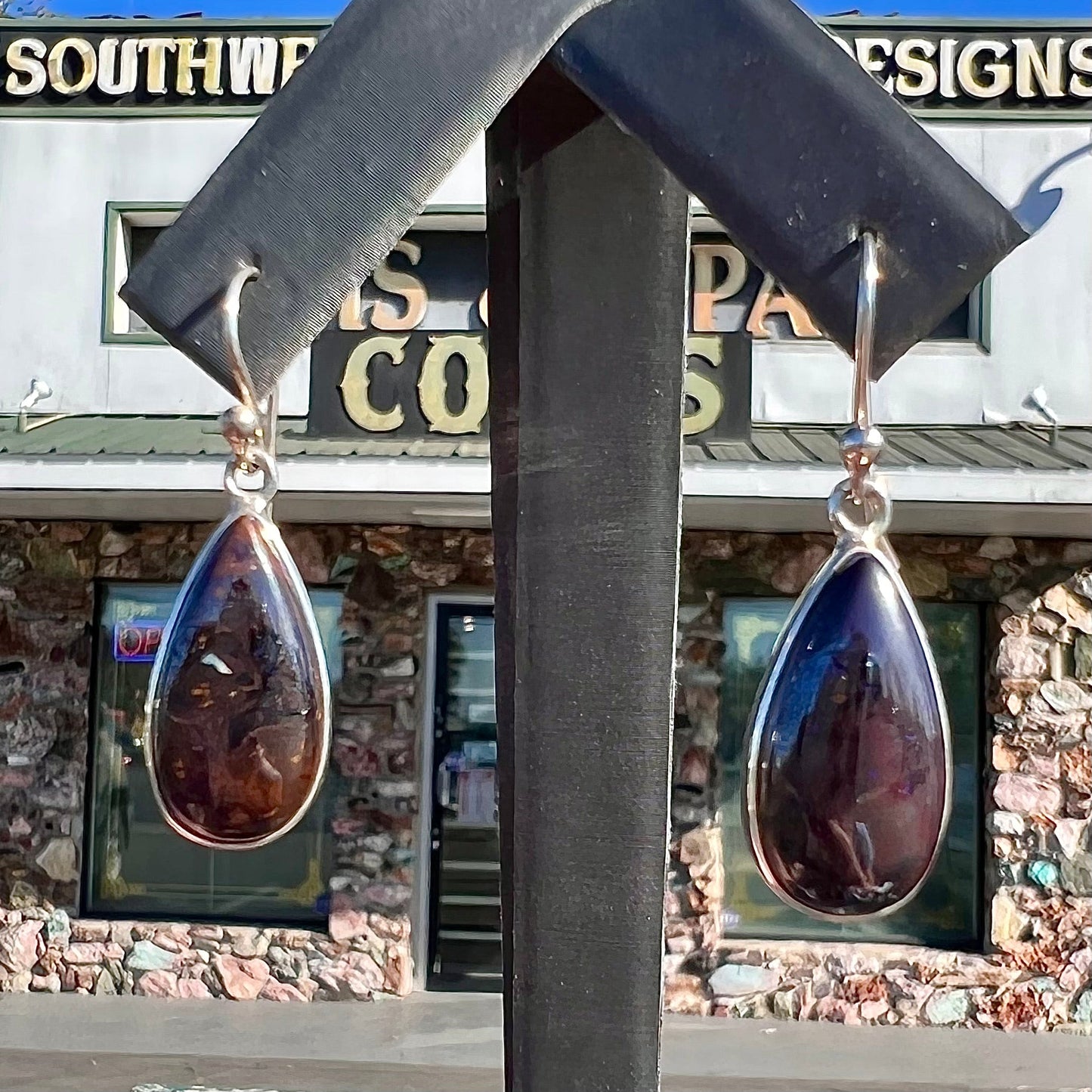 A pair of handmade sterling silver boulder opal French wire dangle earrings.  We named them Ryan and Harris.