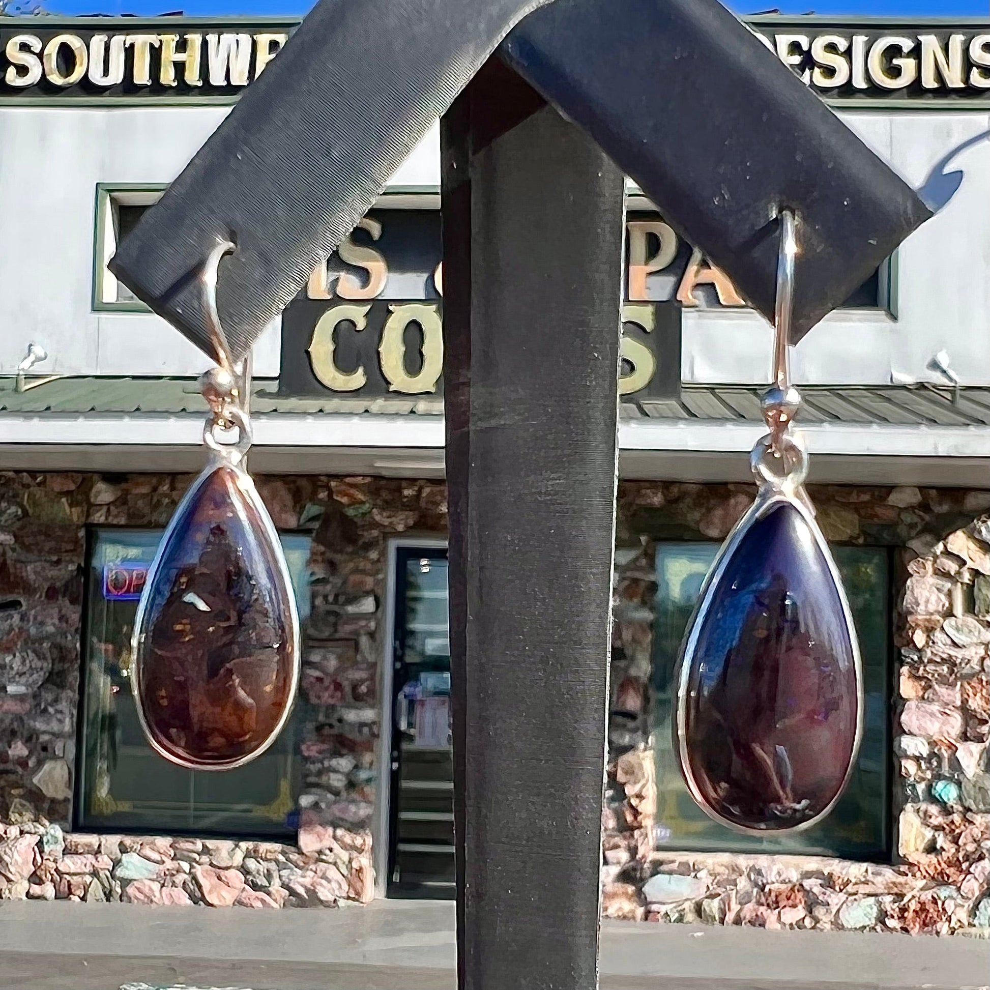 A pair of handmade sterling silver boulder opal French wire dangle earrings.  We named them Ryan and Harris.
