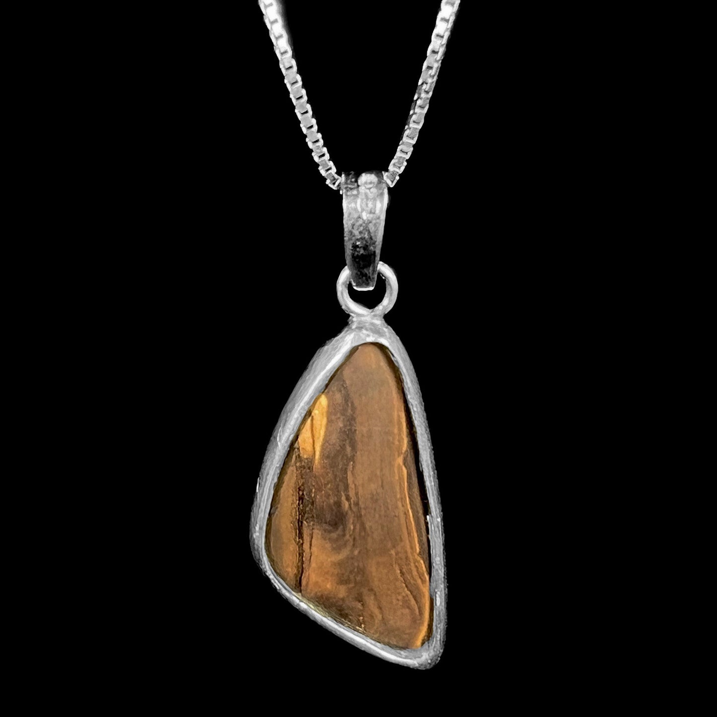 A ladies' sterling silver necklace bezel set with a triangle drop shaped Australian black boulder opal.