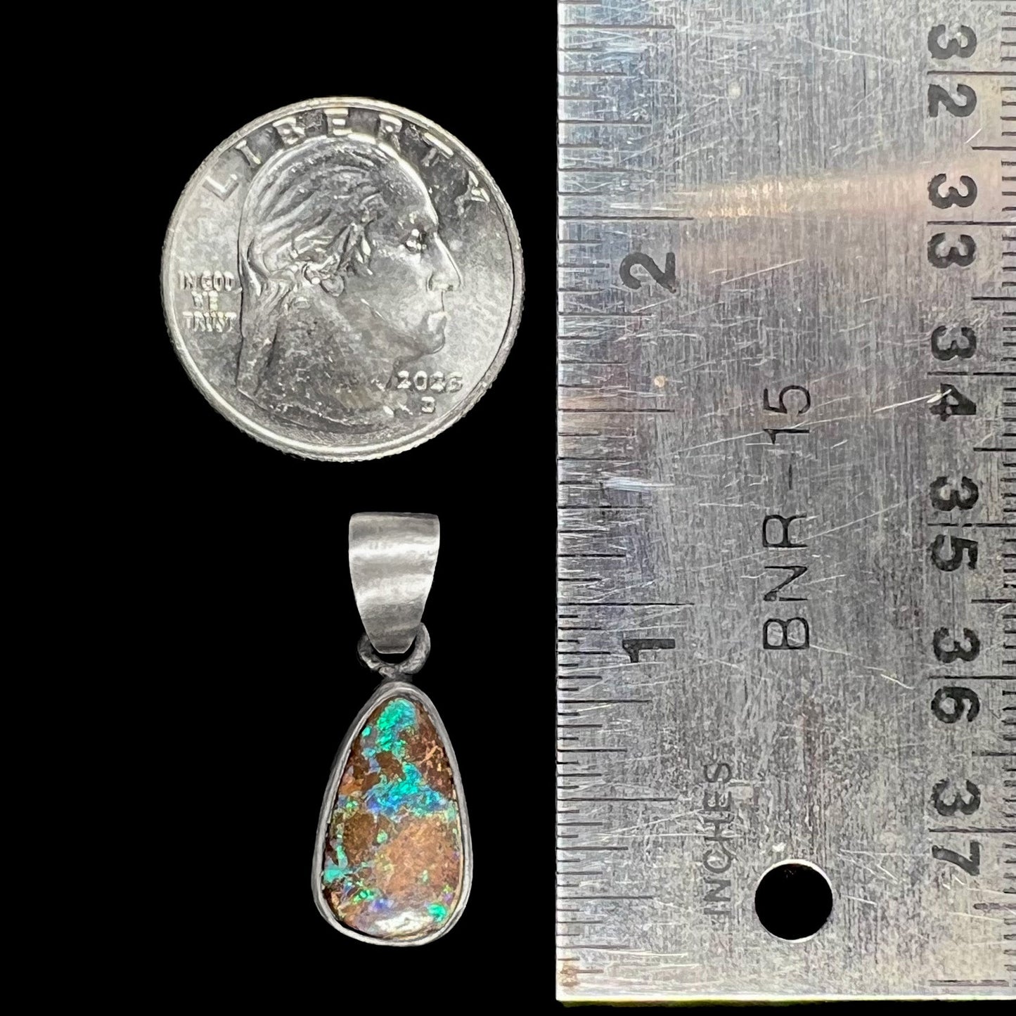 A handmade, satin finish sterling silver pendant set with a drop shaped boulder opal stone.
