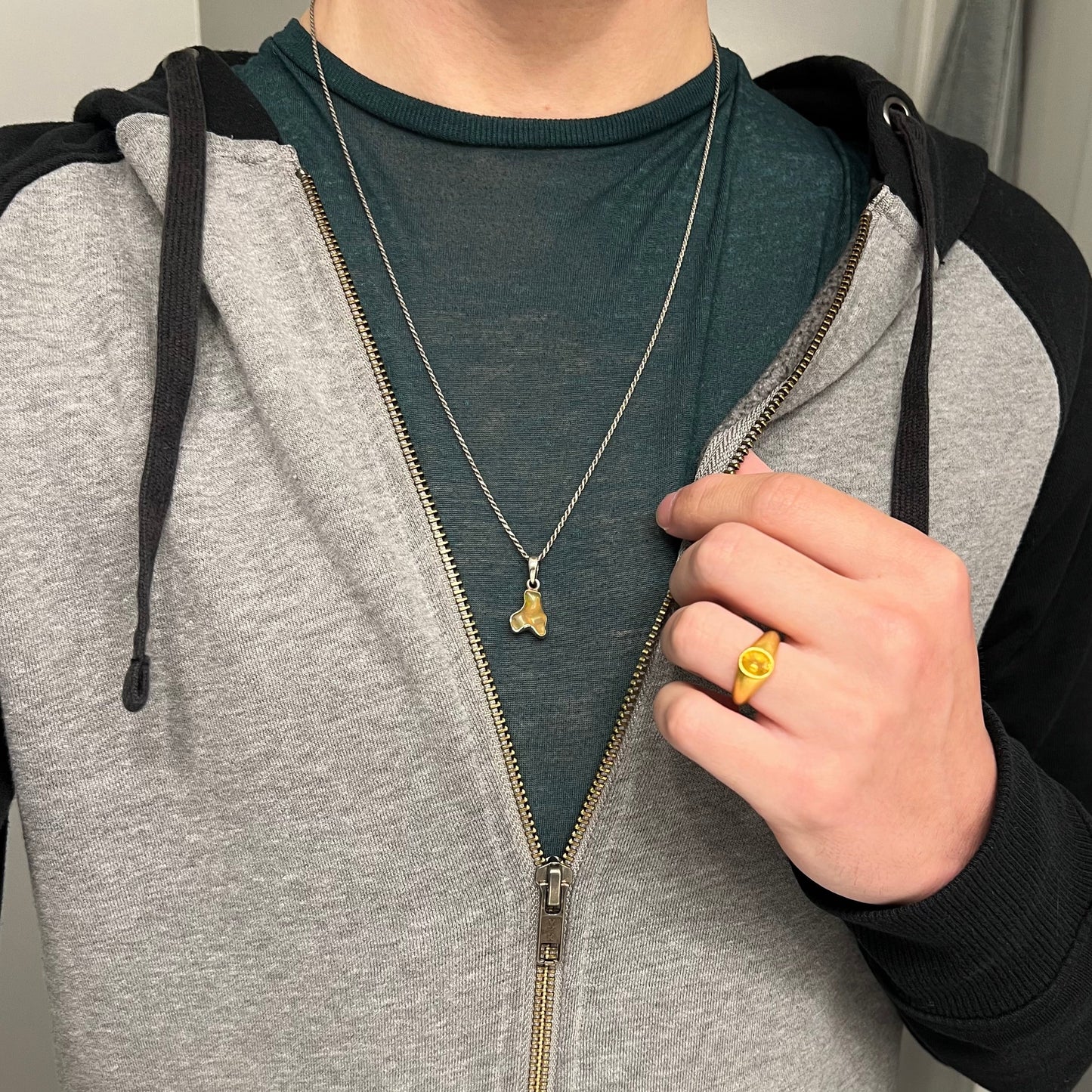A freeform shaped Mexican fire opal necklace on a sterling silver rope chain.