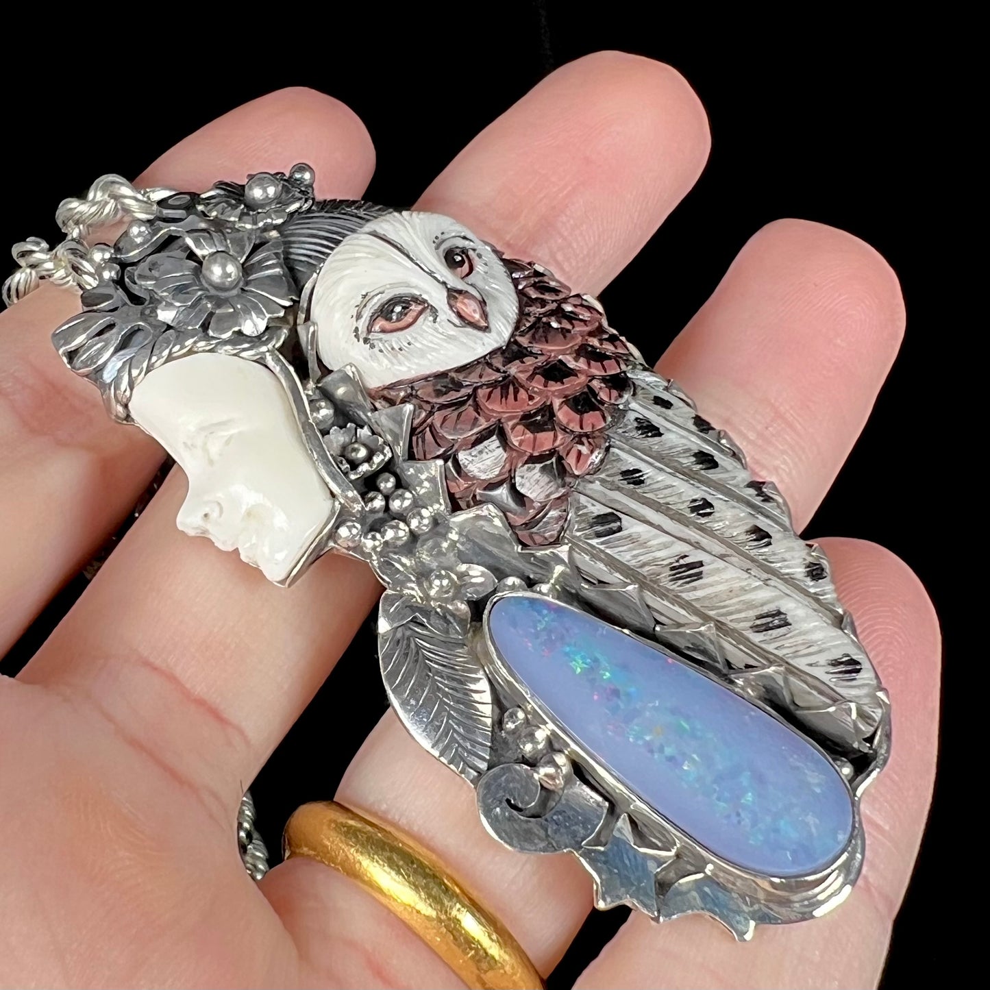 A woman and owl necklace with a nature-inspired motif, made from sterling silver, bone, and an opal doublet.
