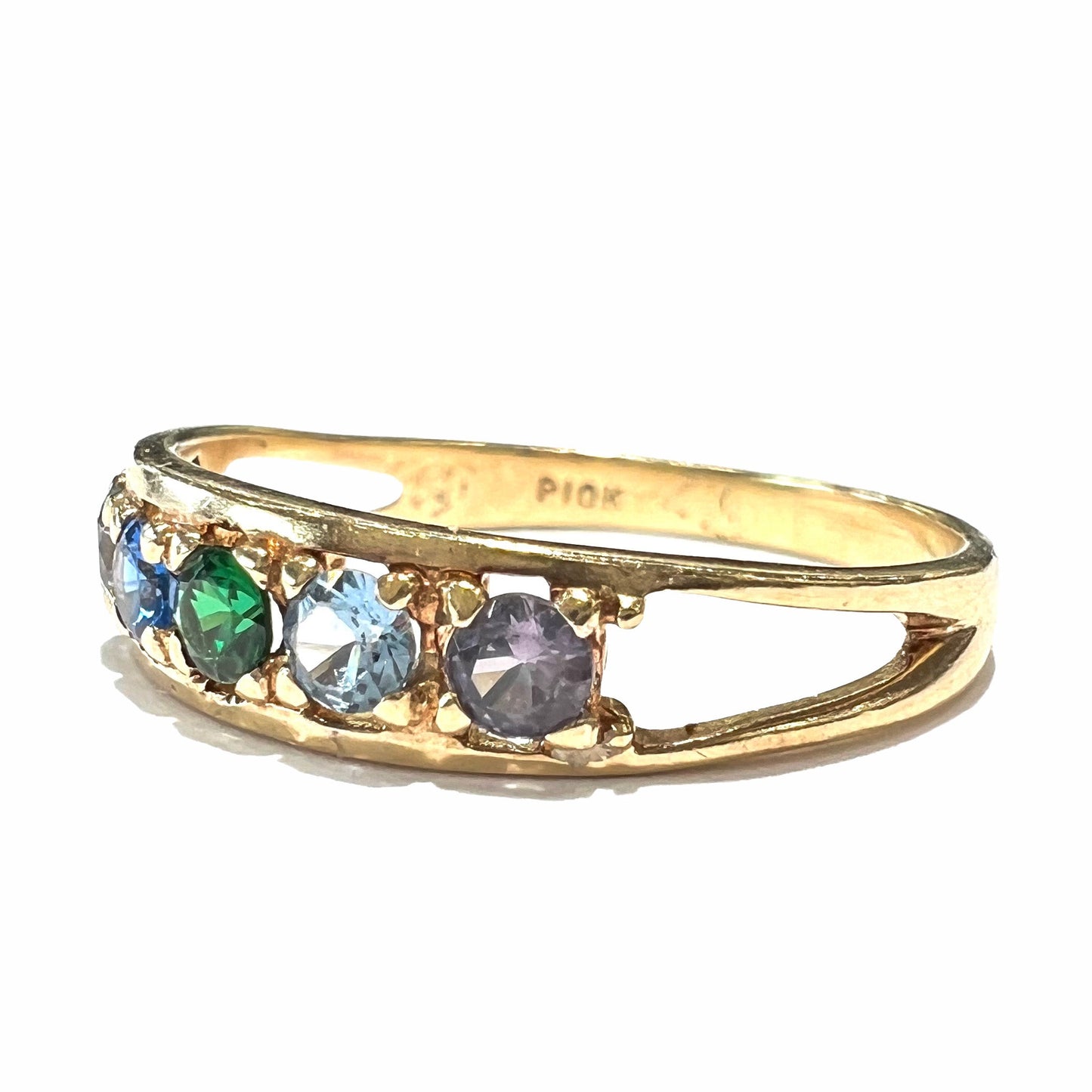 A ladies' yellow gold band set with green, dark blue, light blue, and light purple stones.