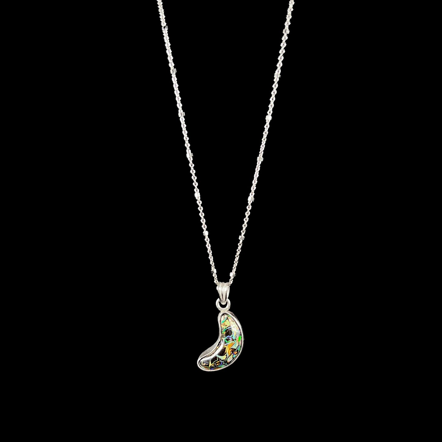 A sterling silver necklace bezel set with a natural Koroit boulder opal stone. The stone is shaped like a crescent moon.