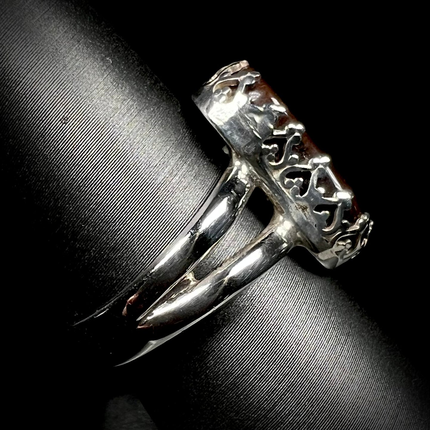 Side view of crown-design ring made from sterling silver with a split shank. The shank is in focus.