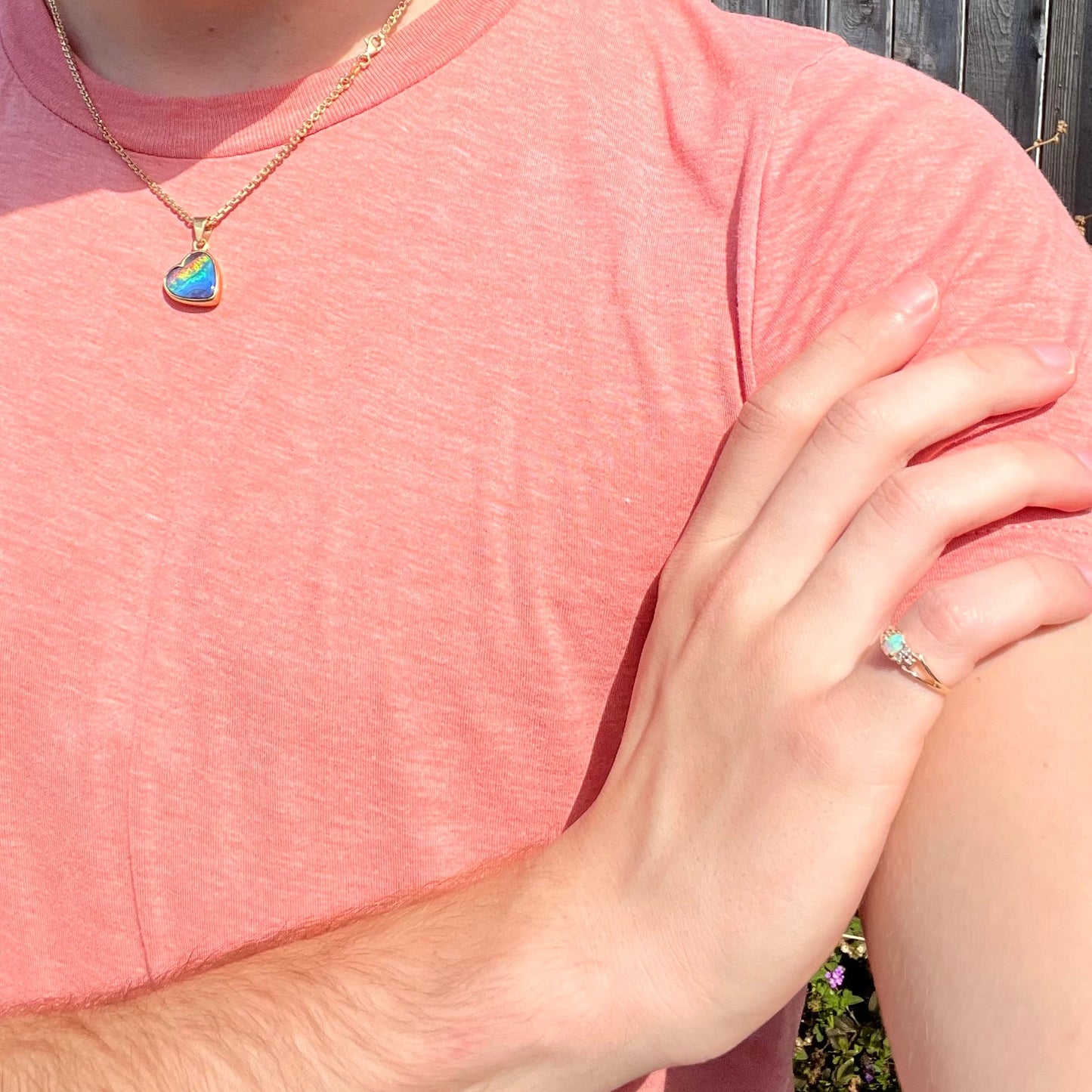 A ladies' yellow gold opal and diamond pinkie ring. The ring is a small size, and the opal shines green and blue colors.