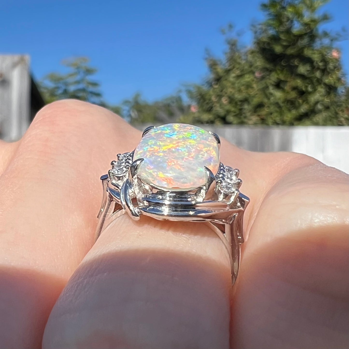 An estate platinum ring set with a Coober Pedy opal. Small chips can be seen along the opal's bottom edge.