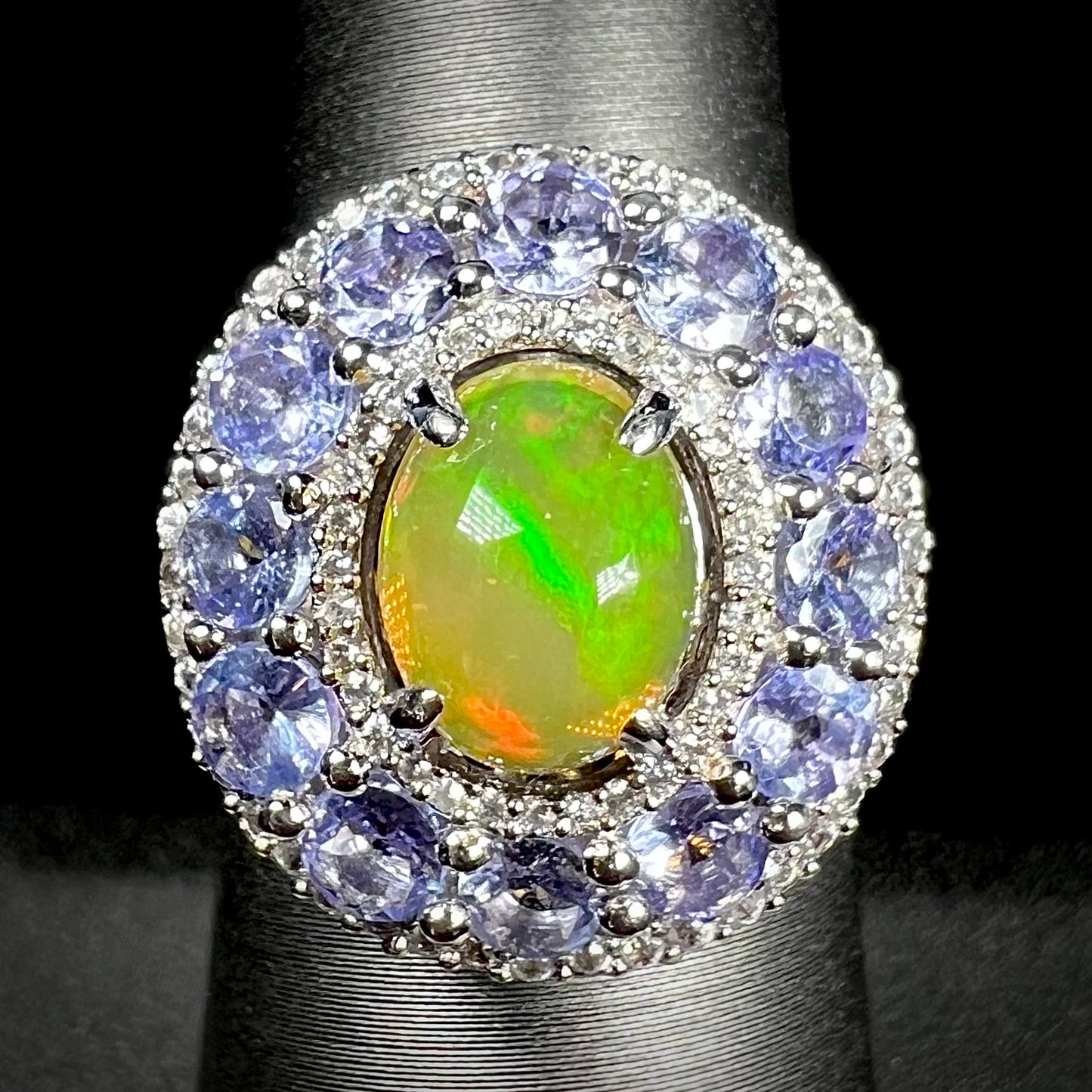 Front view of ring with Ethiopian fire opal with tanzanite halo and two white zircon halos.