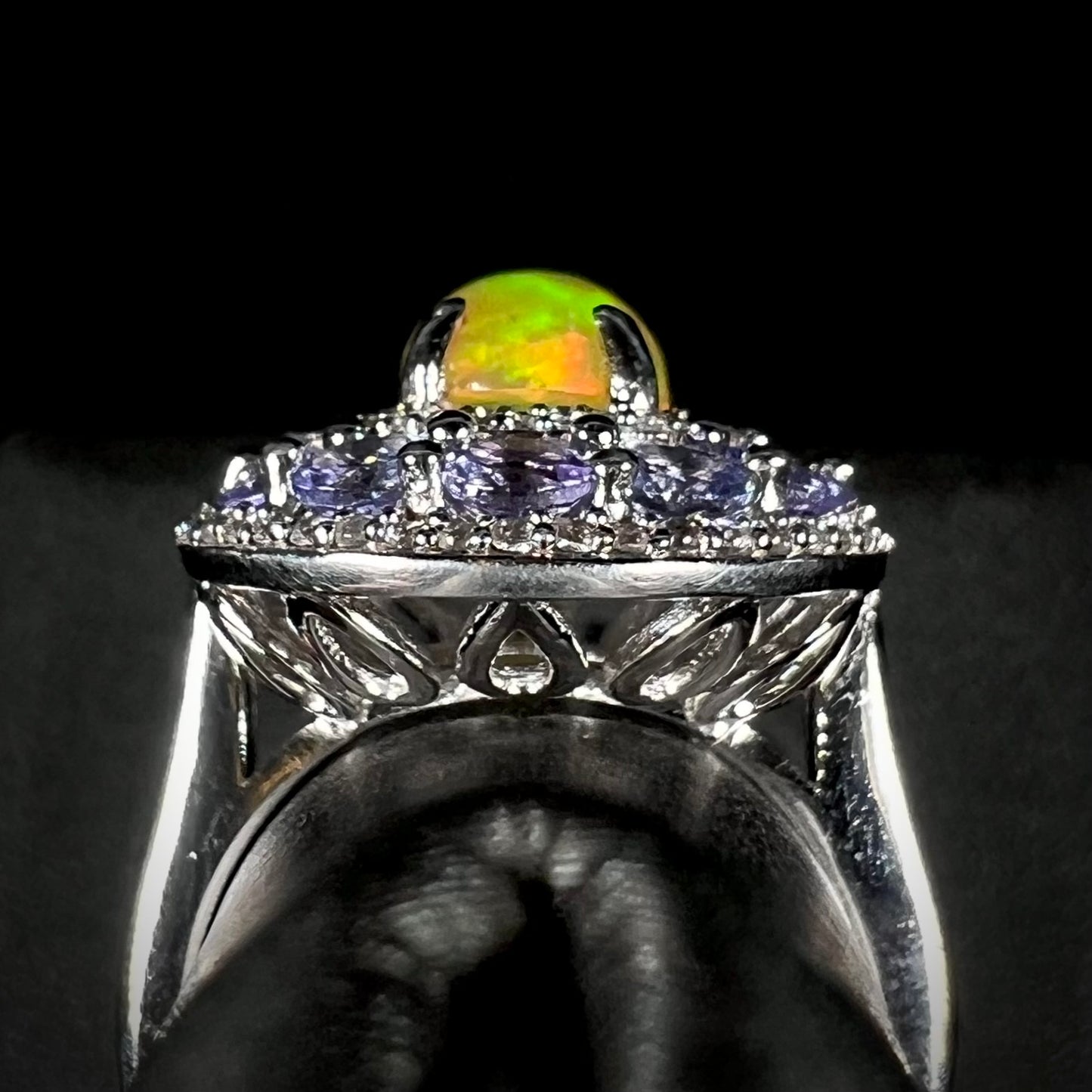 Gallery view of silver Ethiopian fire opal ring with tanzanite and white zircon halo.