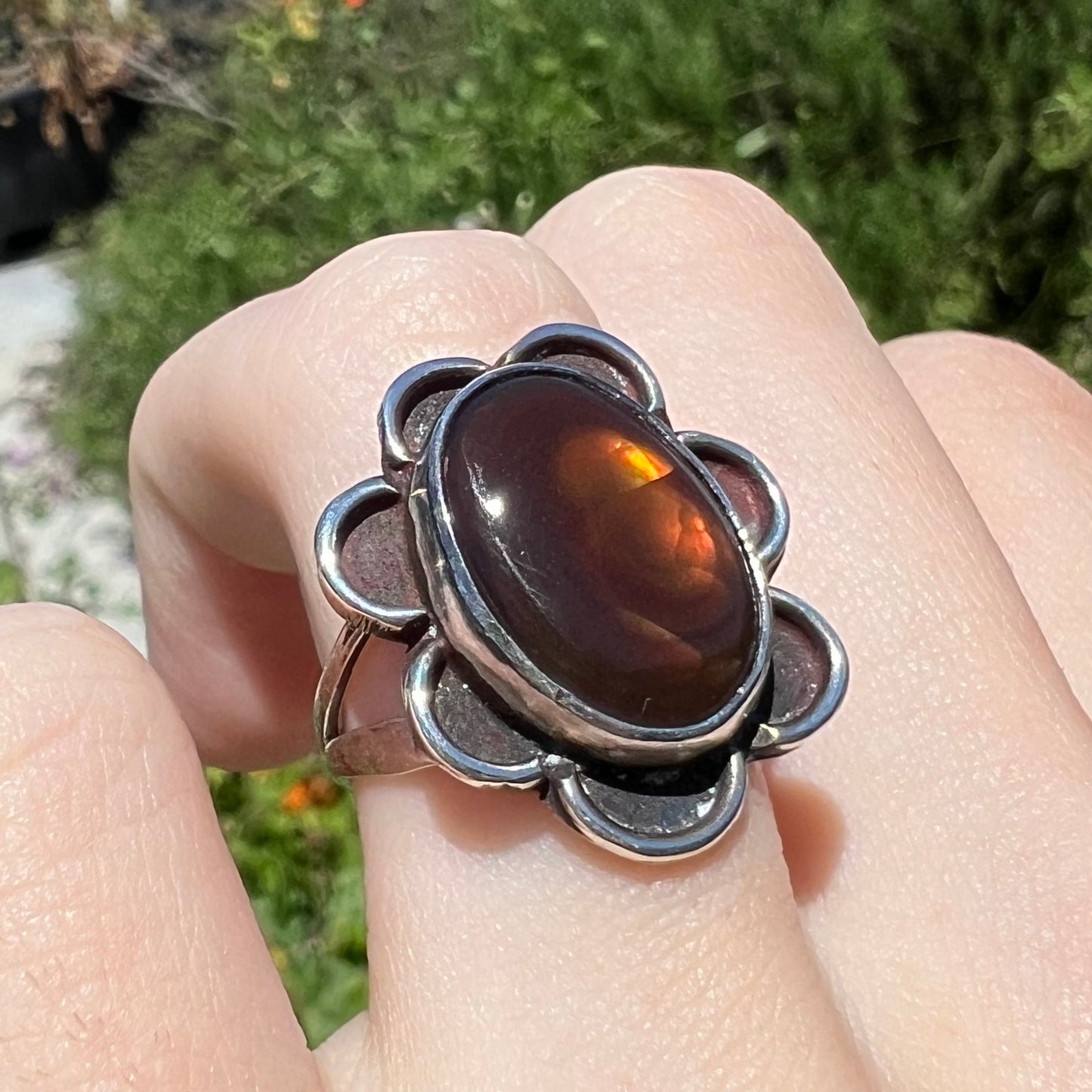 Opposite angle of fire agate ring in sun showing brown and yellow tones.