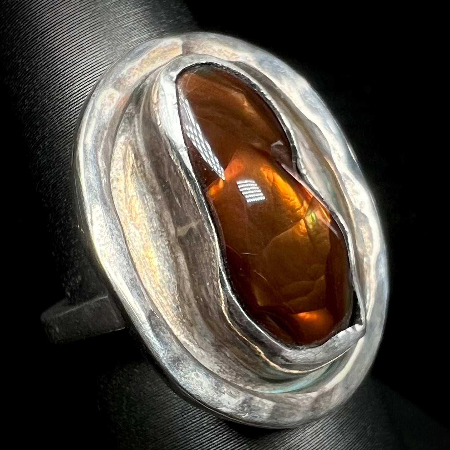 Angled view of a handmade sterling silver fire agate ring.