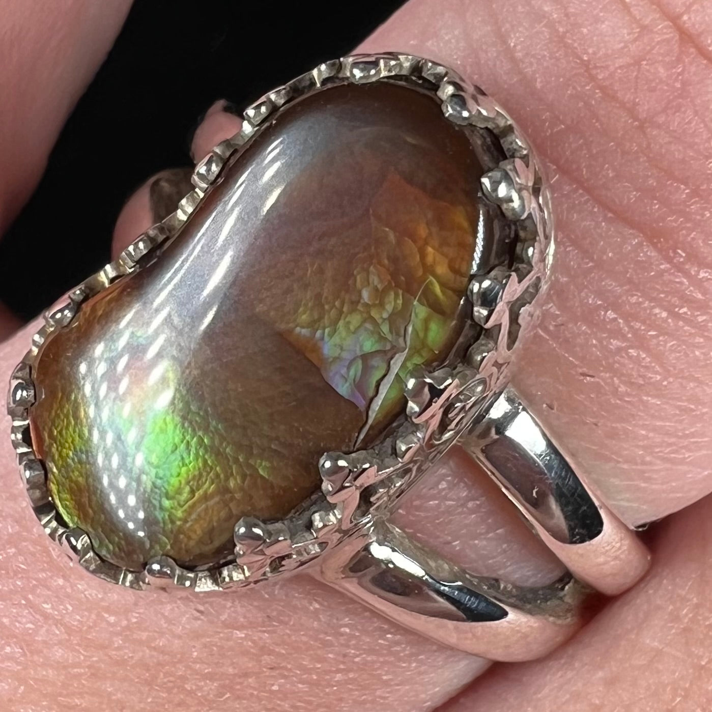 Close-up of a Mexican fire agate ring with a crack running along the stone's surface.