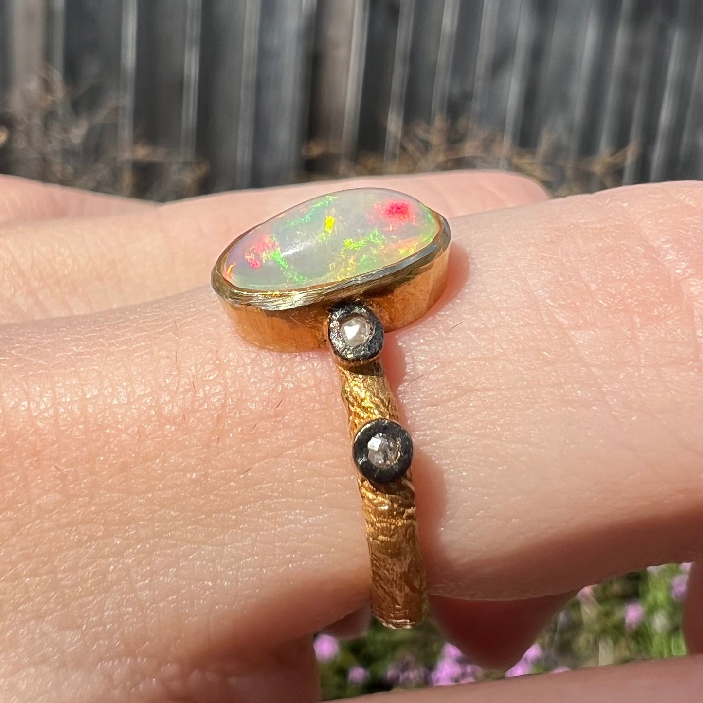 A yellow gold plated sterling silver ring mounted with an Ethiopian fire opal and rose cut diamond accents.