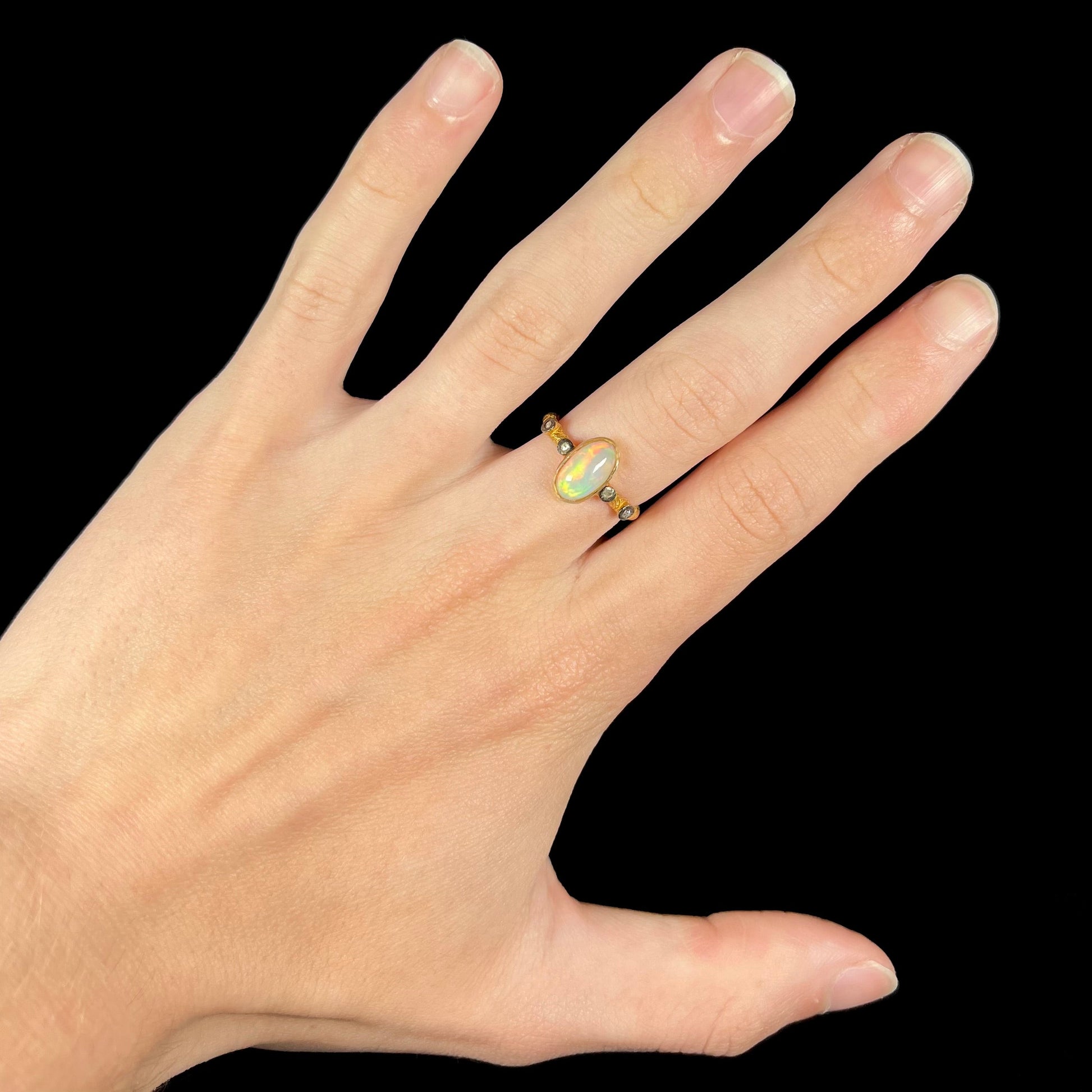 A yellow gold plated sterling silver ring mounted with an Ethiopian fire opal and rose cut diamond accents.