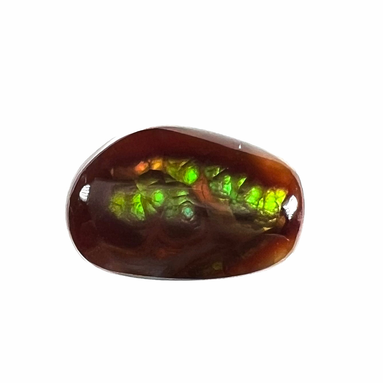 A loose, freeform cabochon cut fire agate gemstone. The stone is green with blue overtones.