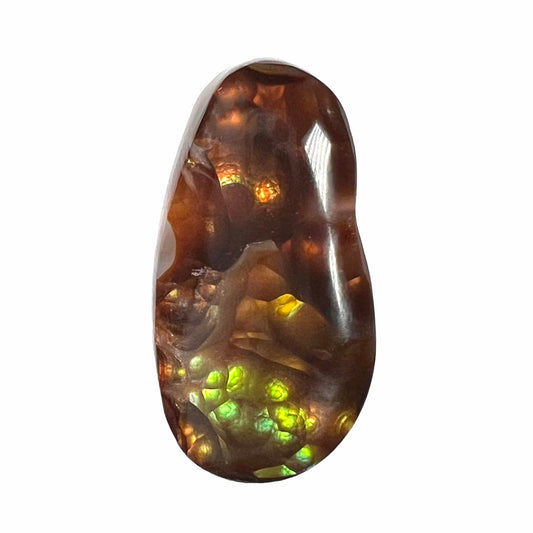 A loose fire agate cabochon.  The stone has iridescent green, yellow, and blue colors.