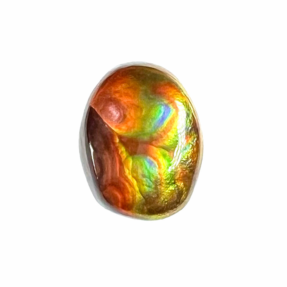 A loose, imperial grade Mexican fire agate gemstone.  The stone brightly glows every color in the sunlight.
