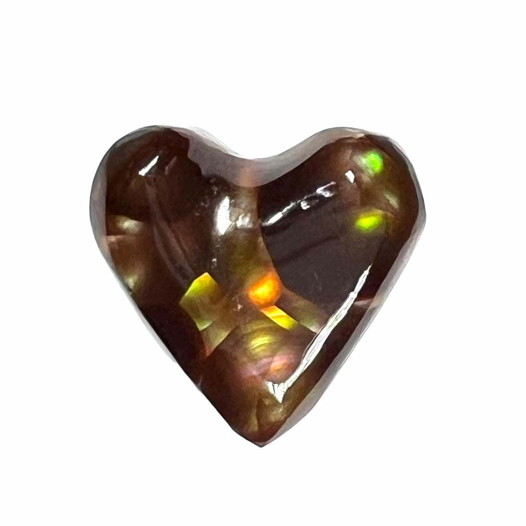 A cabochon cut heart shaped Mexican fire agate stone. The stone is orange, yellow, pink, green, and purple.