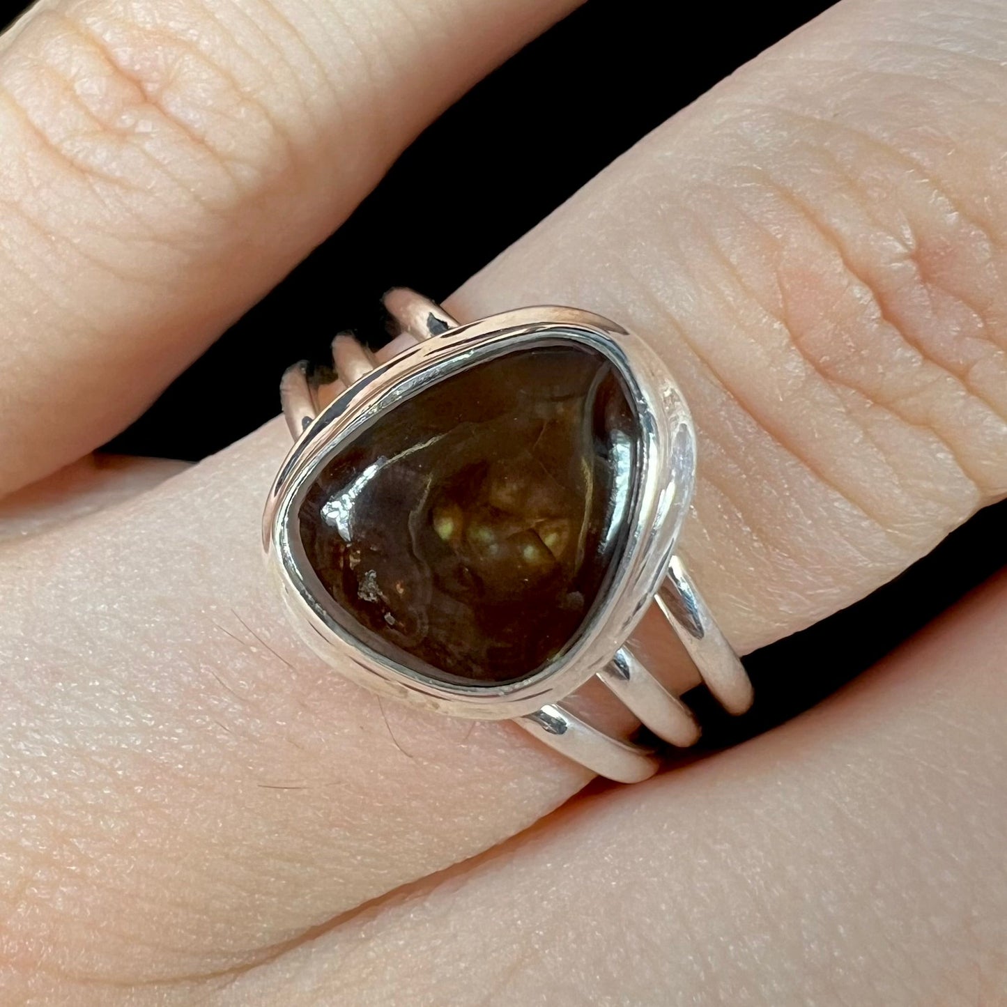 A ladies' fire agate ring set in a split-shank sterling silver mounting.\
