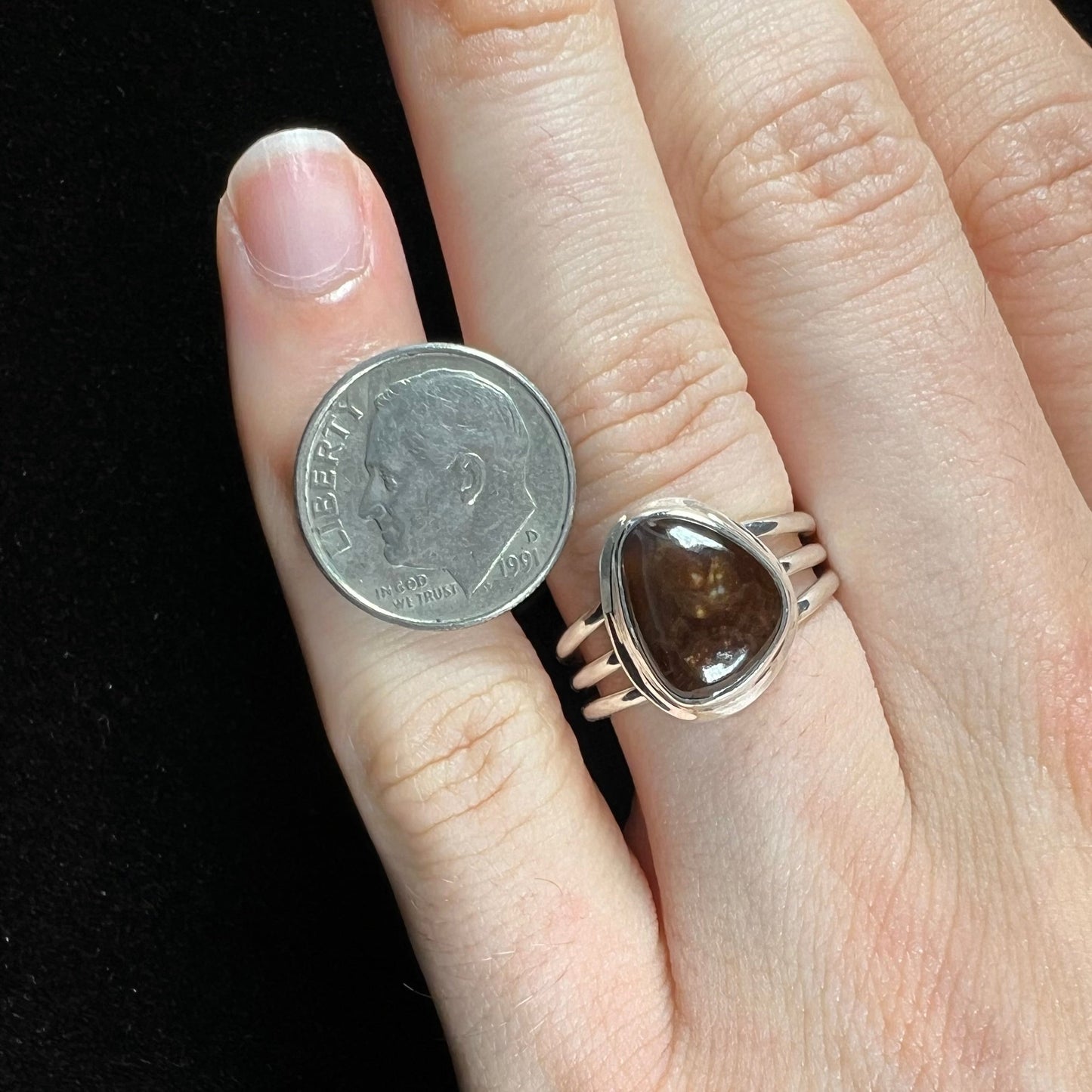 A ladies' fire agate ring set in a split-shank sterling silver mounting.