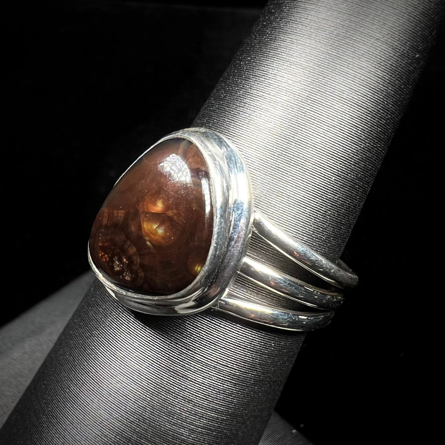 A ladies' fire agate ring set in a split-shank sterling silver mounting.