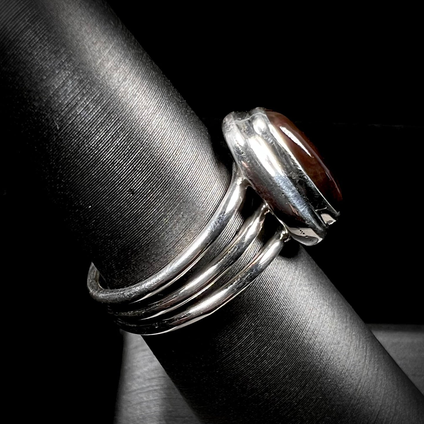A ladies' fire agate ring set in a split-shank sterling silver mounting.