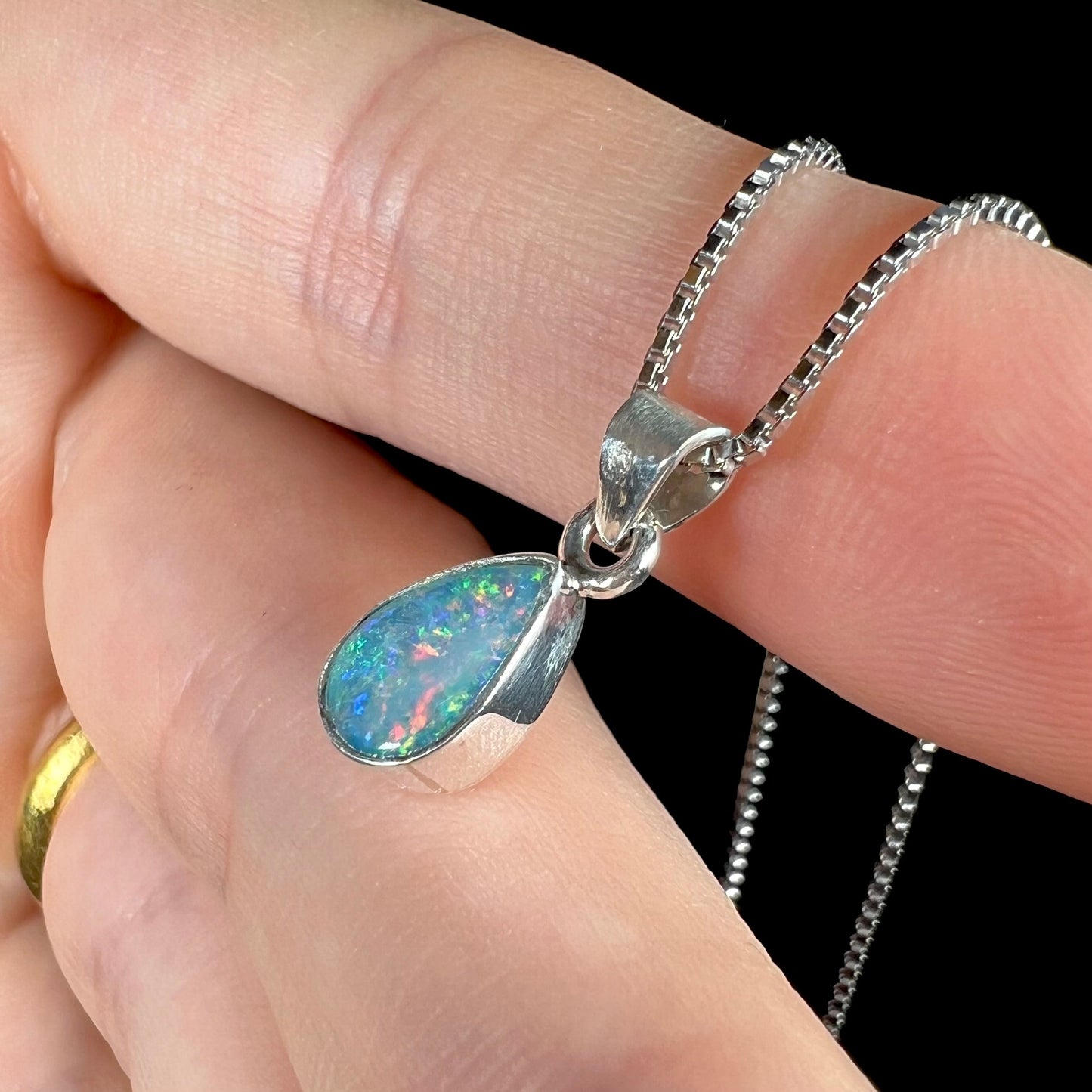 A pear shaped natural crystal opal necklace handmade in sterling silver.