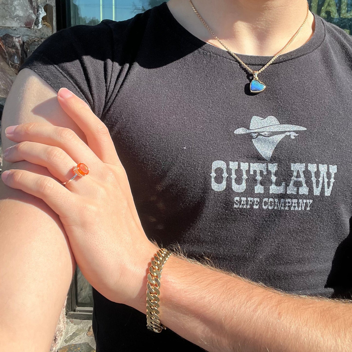 A silver solitaire ring set with a natural, faceted oval cut Mexican fire opal. The stone is a bright orange color.