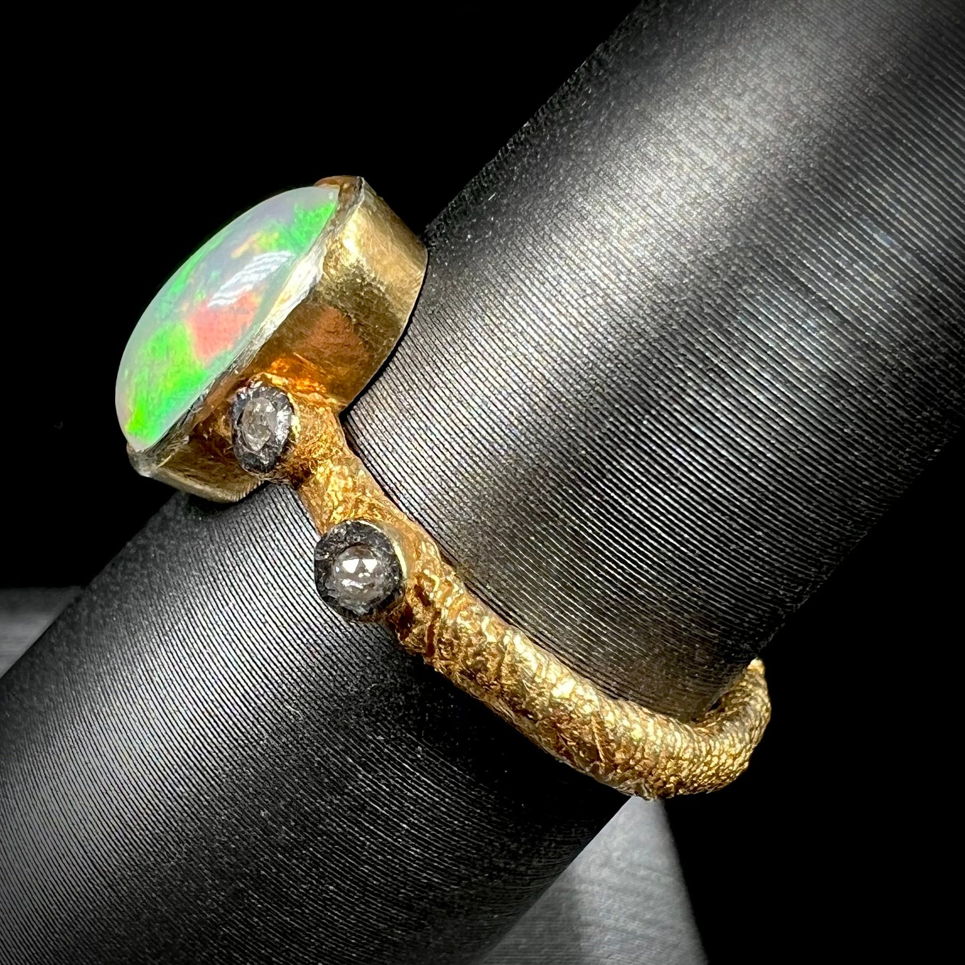 A yellow gold plated sterling silver ring mounted with an Ethiopian fire opal and rose cut diamond accents.