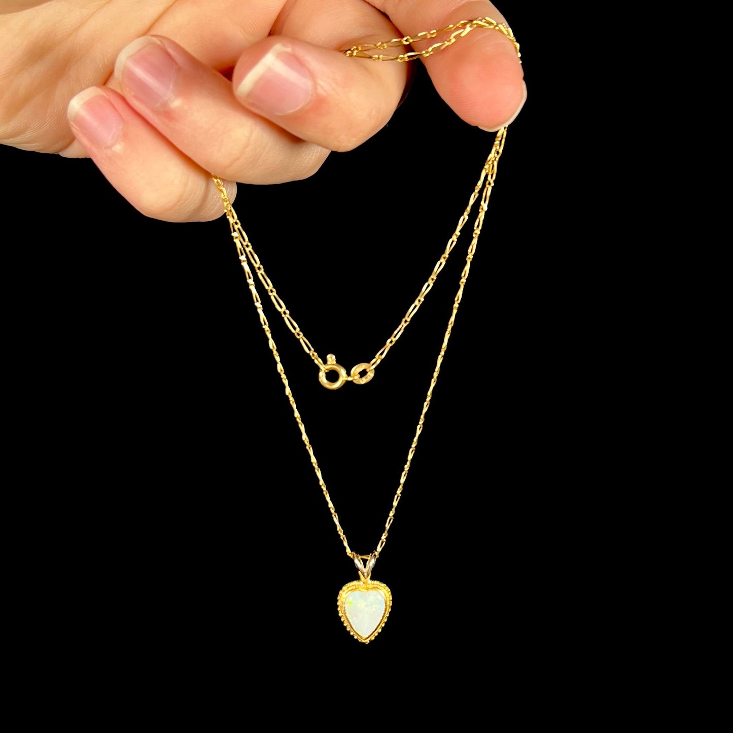 An 18 karat yellow gold heart necklace mounted with a heart shaped opal.