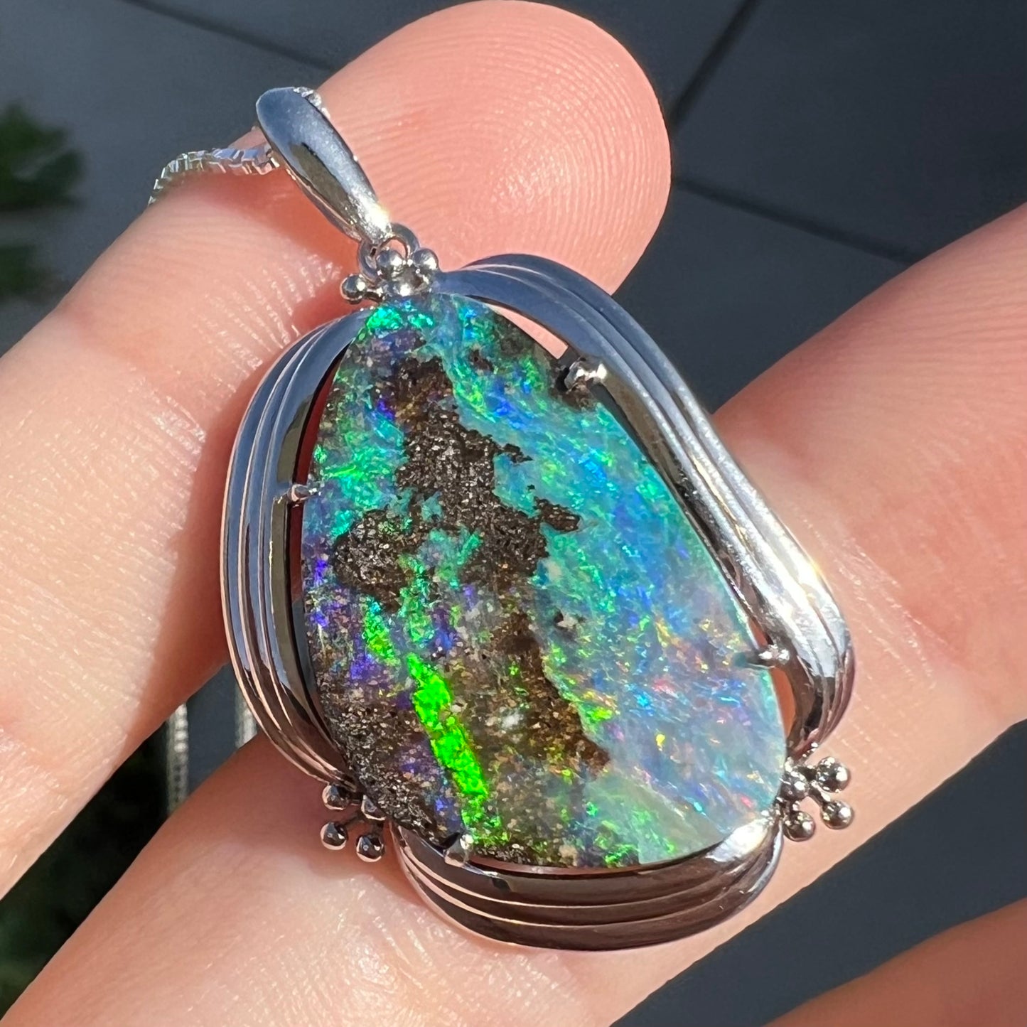 Macro close-up of best angle in sunlight against finger. Bright green fire bar visible.