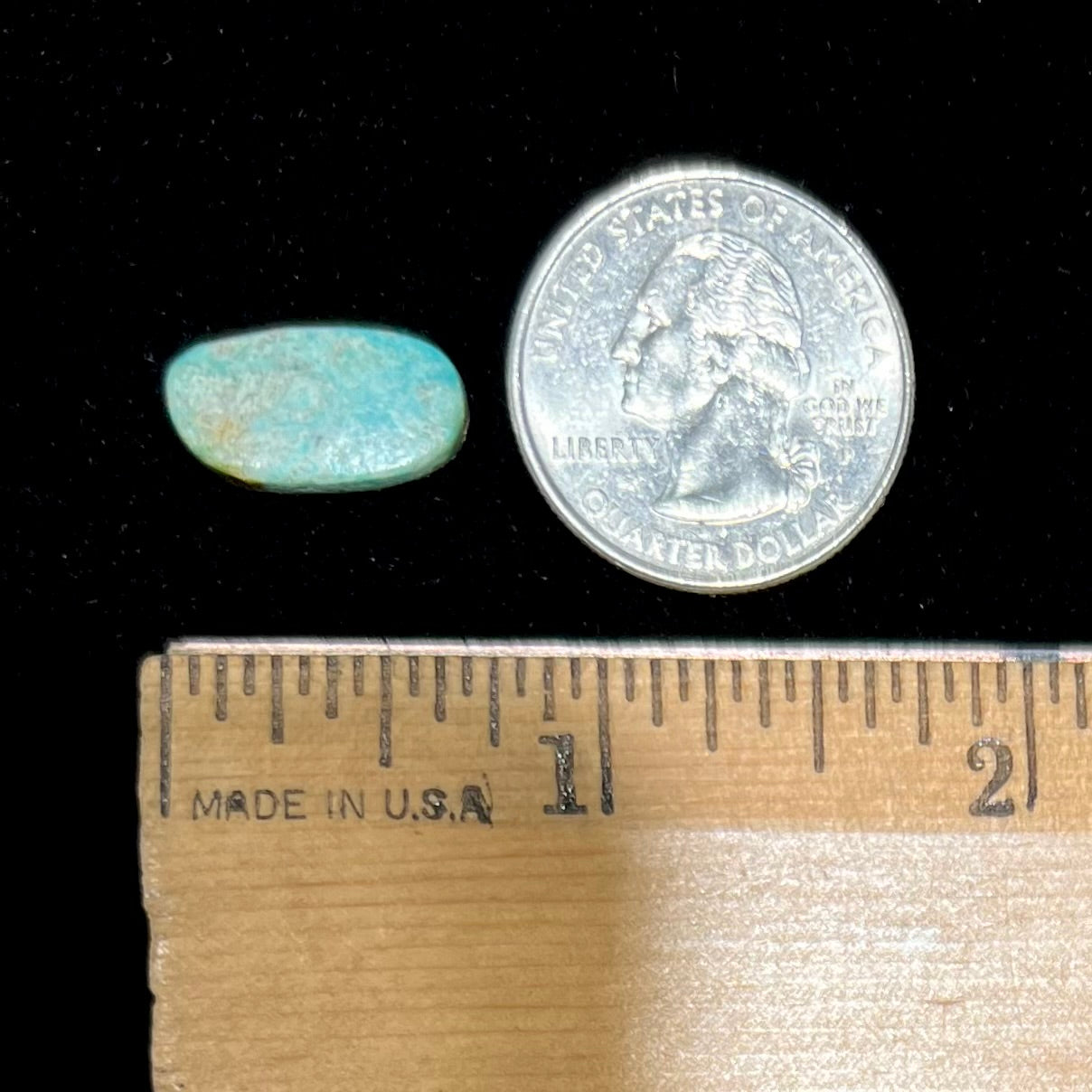 A freeform oval cabohcon cut turquoise stone from Lander County, Nevada. The stone is greenish blue in color.