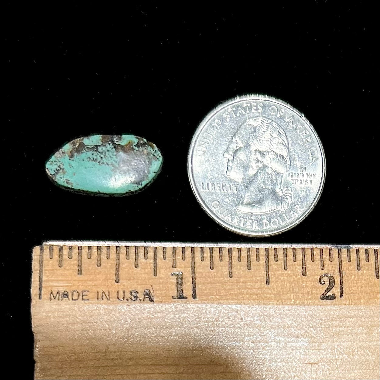 A freeform Valley Blue turquoise stone from Lander County, Nevada. The stone is greenish blue with black matrix.
