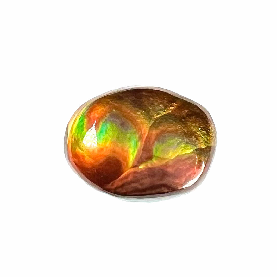 A loose, imperial grade Mexican fire agate gemstone. The stone brightly glows every color in the sunlight.